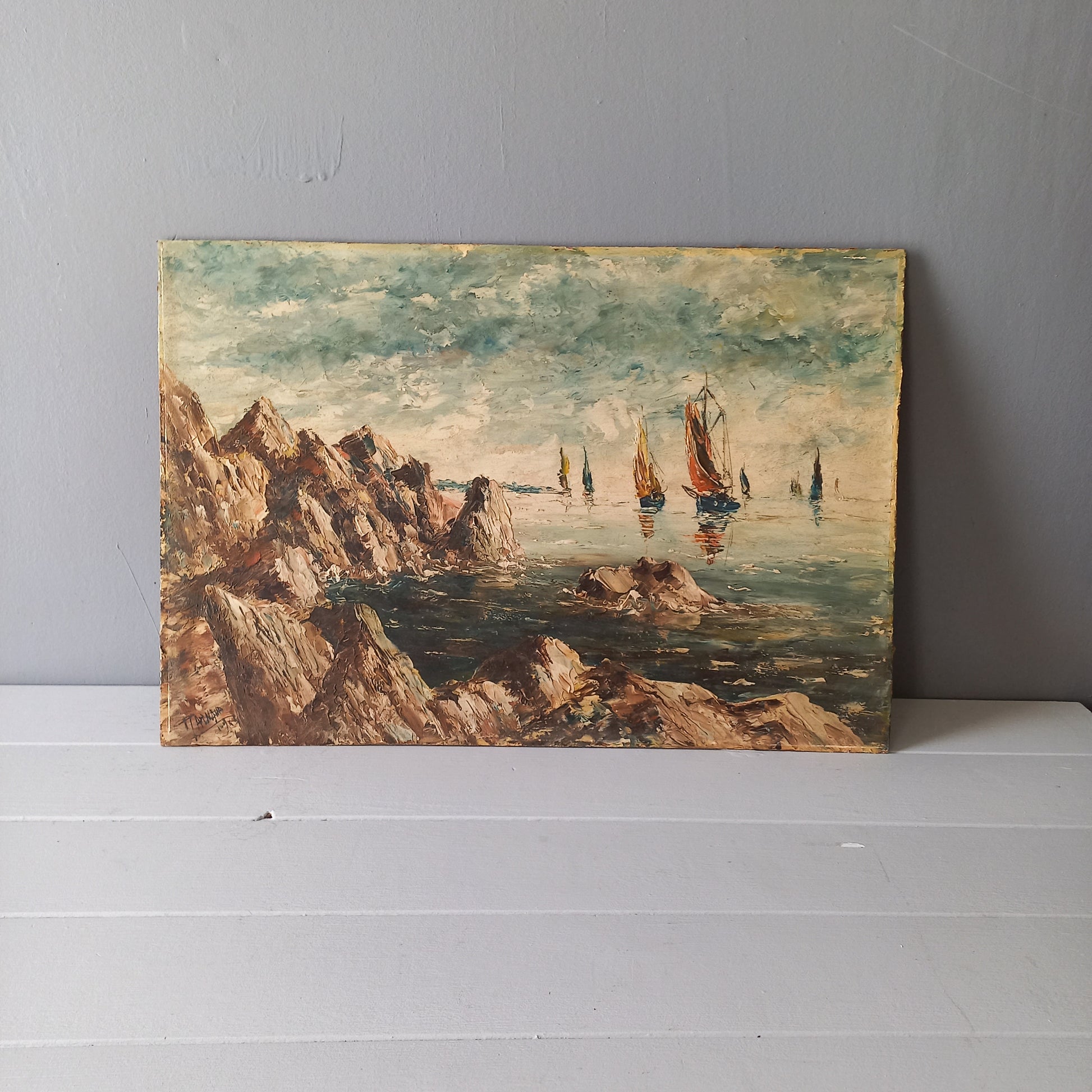 A beautiful piece of original French art depicting sailing boats on a rocky coastline. The painting is wonderfully done in a 'painterly' fashion with thick, vibrant oil paint strokes on hardboard. It has been signed and dated by the artist.
