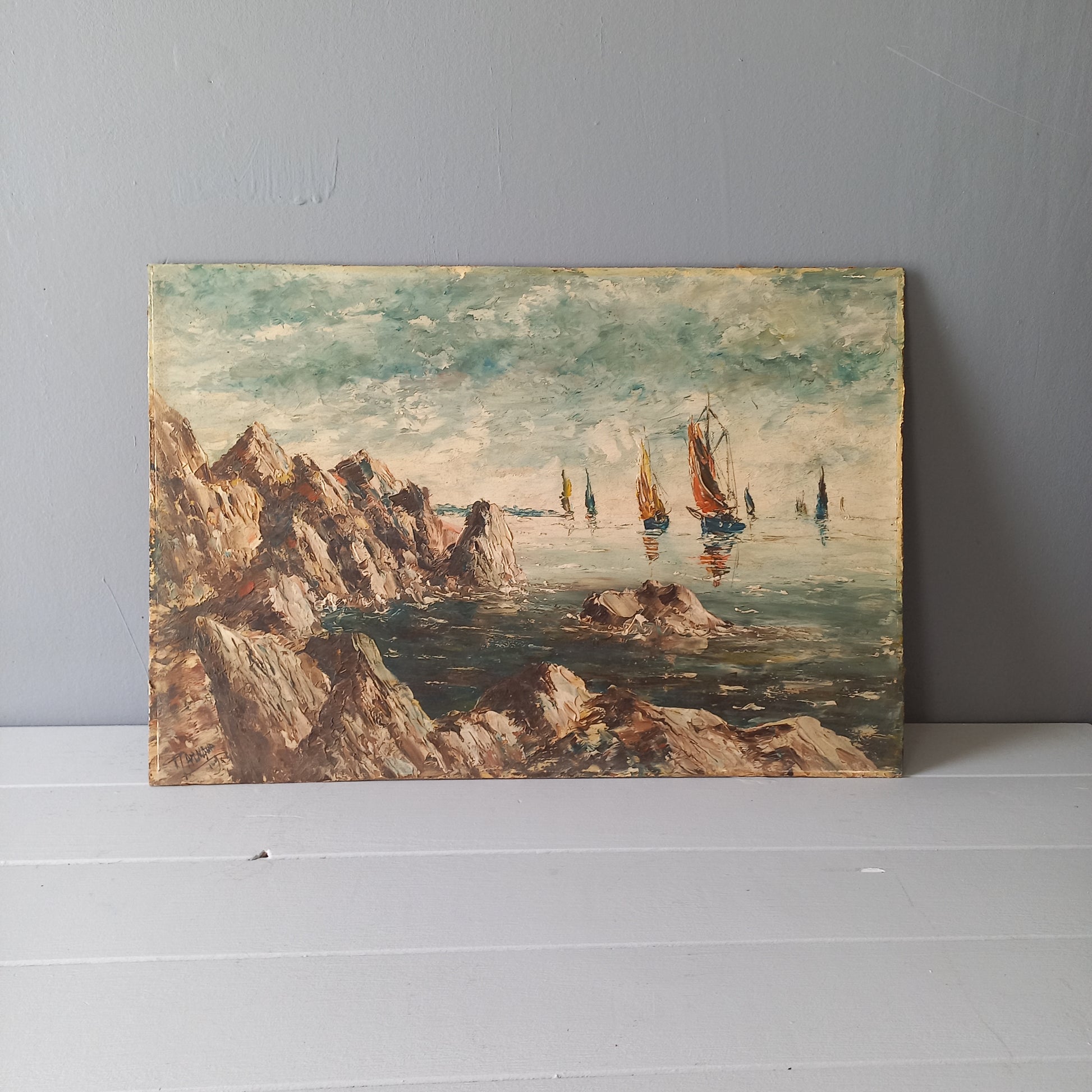 A beautiful piece of original French art depicting sailing boats on a rocky coastline. The painting is wonderfully done in a 'painterly' fashion with thick, vibrant oil paint strokes on hardboard. It has been signed and dated by the artist.