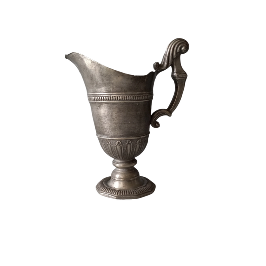 An absolutely fabulous antique pewter pitcher with wonderful decorative patterning around its circumference. It was purchased from an antique dealer in south west France. This piece is very interesting and quite crude in some ways with its tilt forward (there is a little wobble). Over the years it has picked up some dings and tarnishing although it's still a solid and heavy piece. Underneath there is a maker's mark of a winged figure and what looks like a 'J' and possibly a 'B' (see photos).