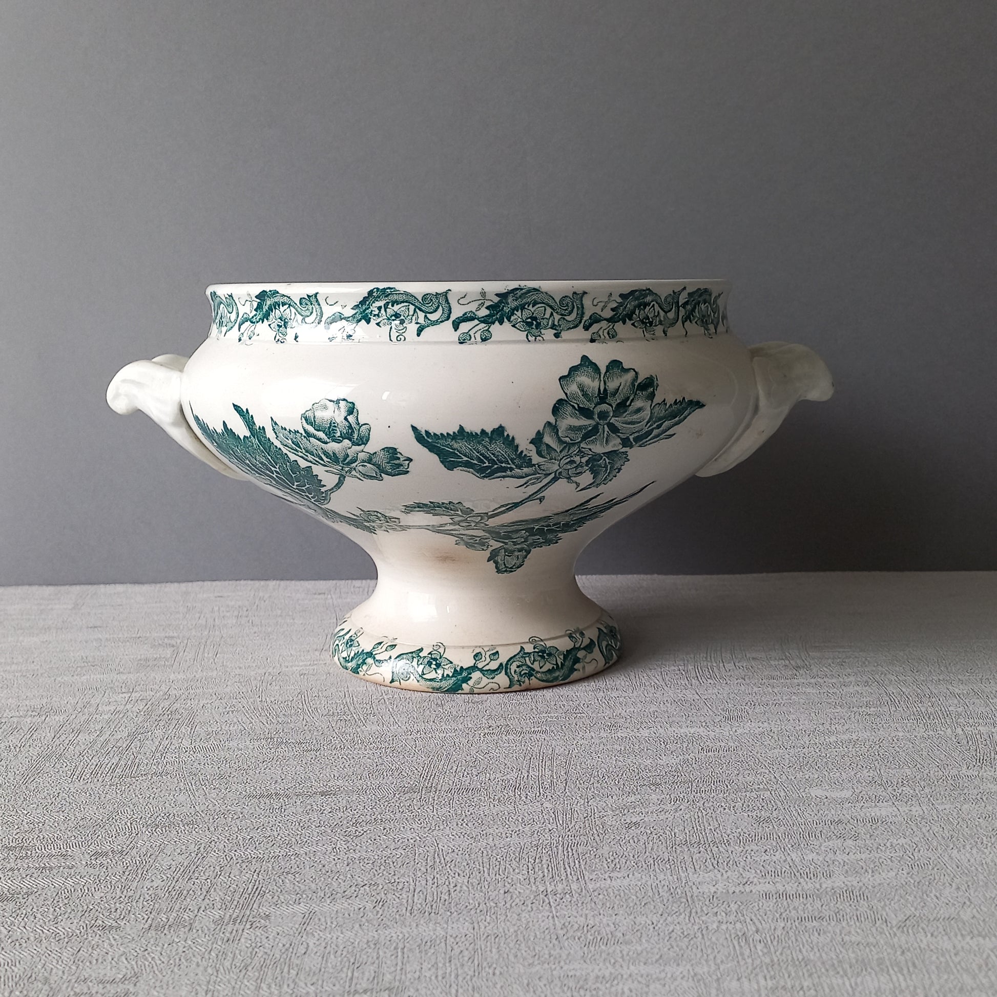 A delightful small-sized antique ironstone soup tureen by French manufacturer, St. Amand. This tureen is adorned with a beautiful teal coloured floral transferware pattern and has a splendid little handle on the lid. In summary, an elegant piece with just enough patina of age to give it character.
