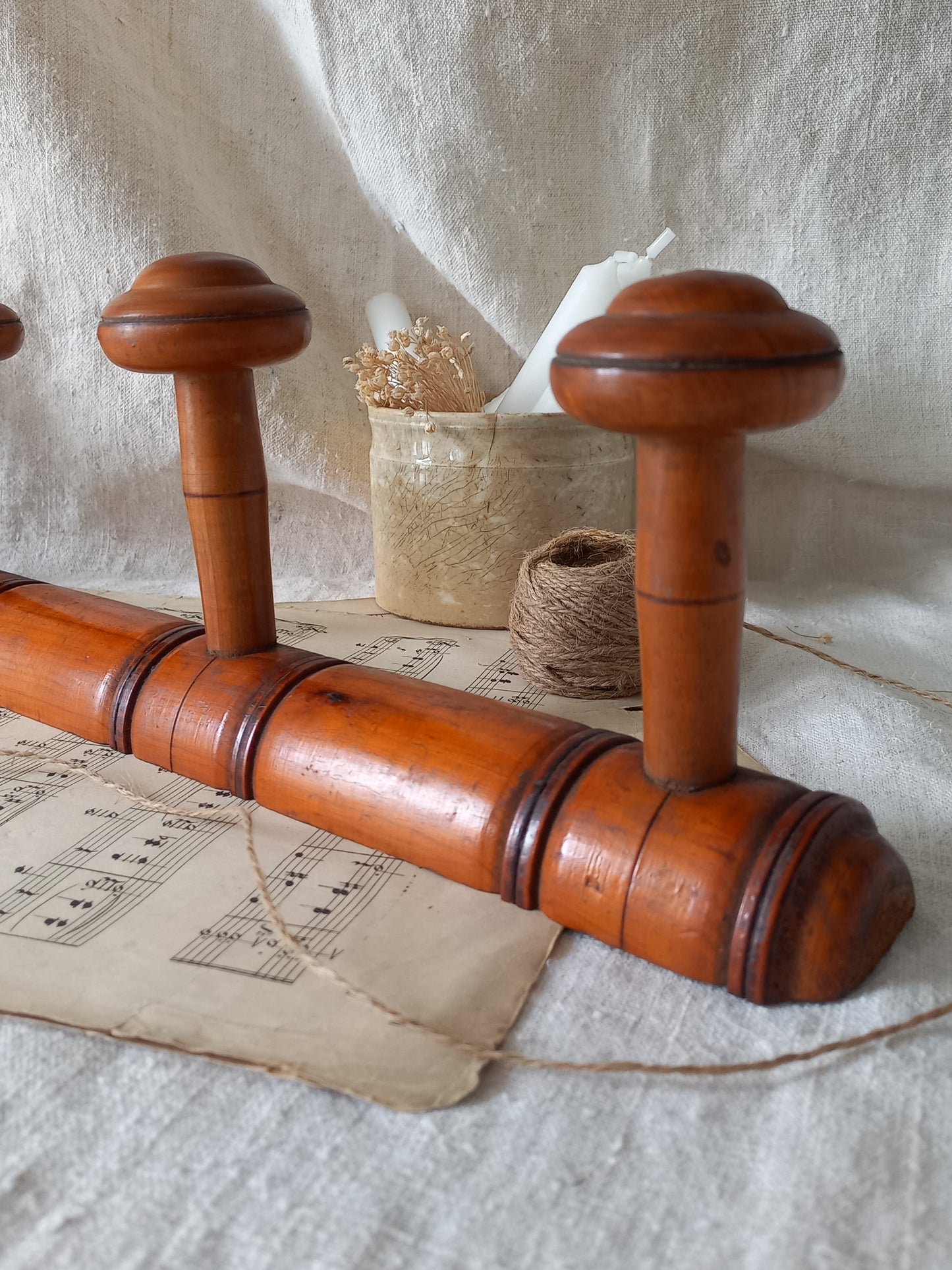 Close-up of French Antique Faux Bamboo Coat Rack with Four Pegs in rustic setting.