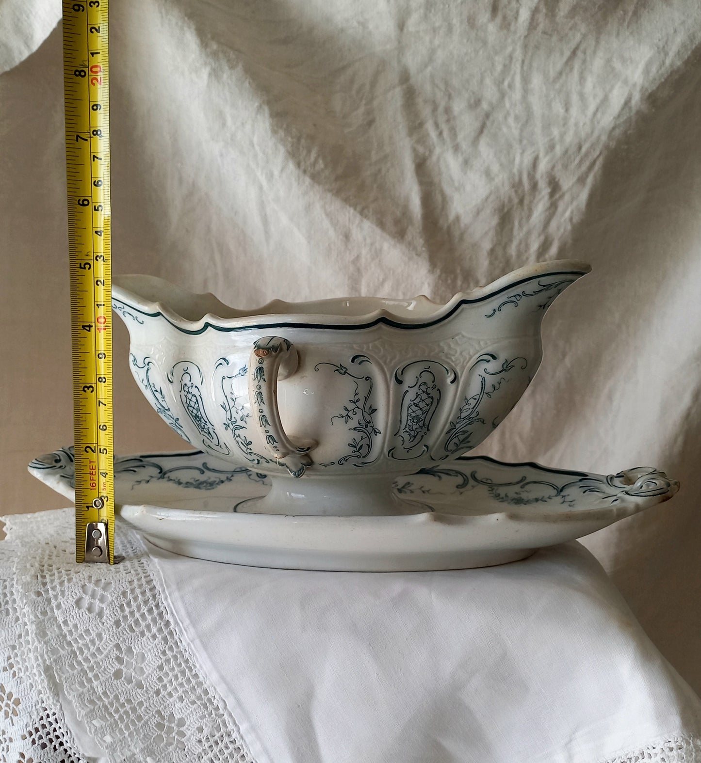 A large and elegant antique ironstone sauce boat with a green floral transferware pattern, a grand-looking, heavy piece. These days this piece will make an excellent piece of decor in any home, especially those of a country or farmhouse nature.