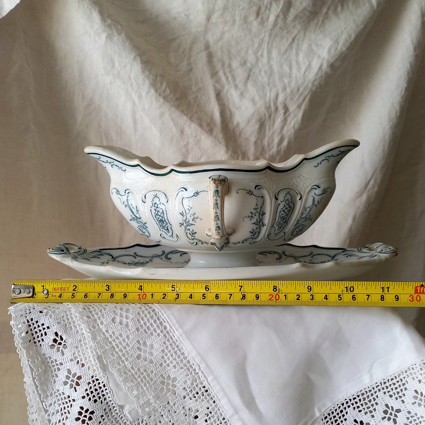 A large and elegant antique ironstone sauce boat with a green floral transferware pattern, a grand-looking, heavy piece. These days this piece will make an excellent piece of decor in any home, especially those of a country or farmhouse nature.