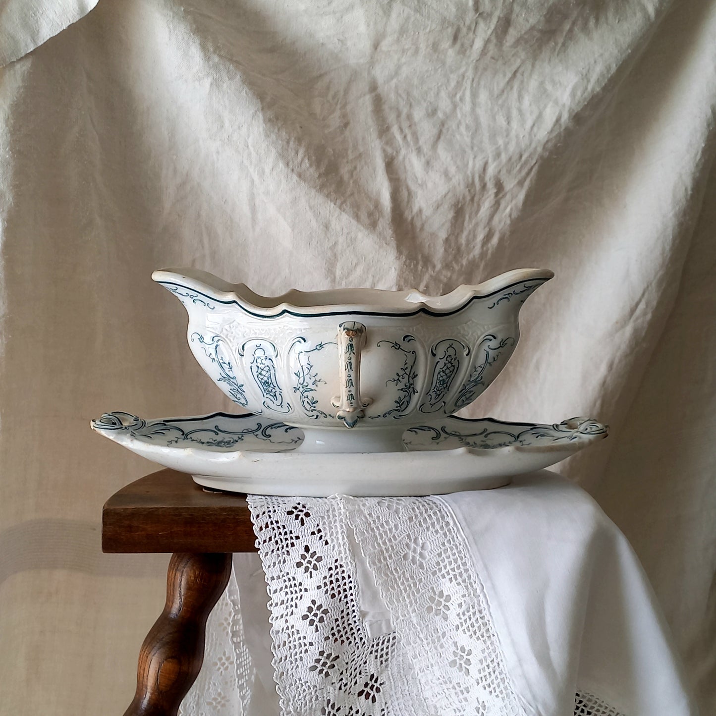 A large and elegant antique ironstone sauce boat with a green floral transferware pattern, a grand-looking, heavy piece. These days this piece will make an excellent piece of decor in any home, especially those of a country or farmhouse nature.