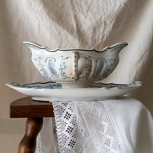 A large and elegant antique ironstone sauce boat with a green floral transferware pattern, a grand-looking, heavy piece. These days this piece will make an excellent piece of decor in any home, especially those of a country or farmhouse nature.