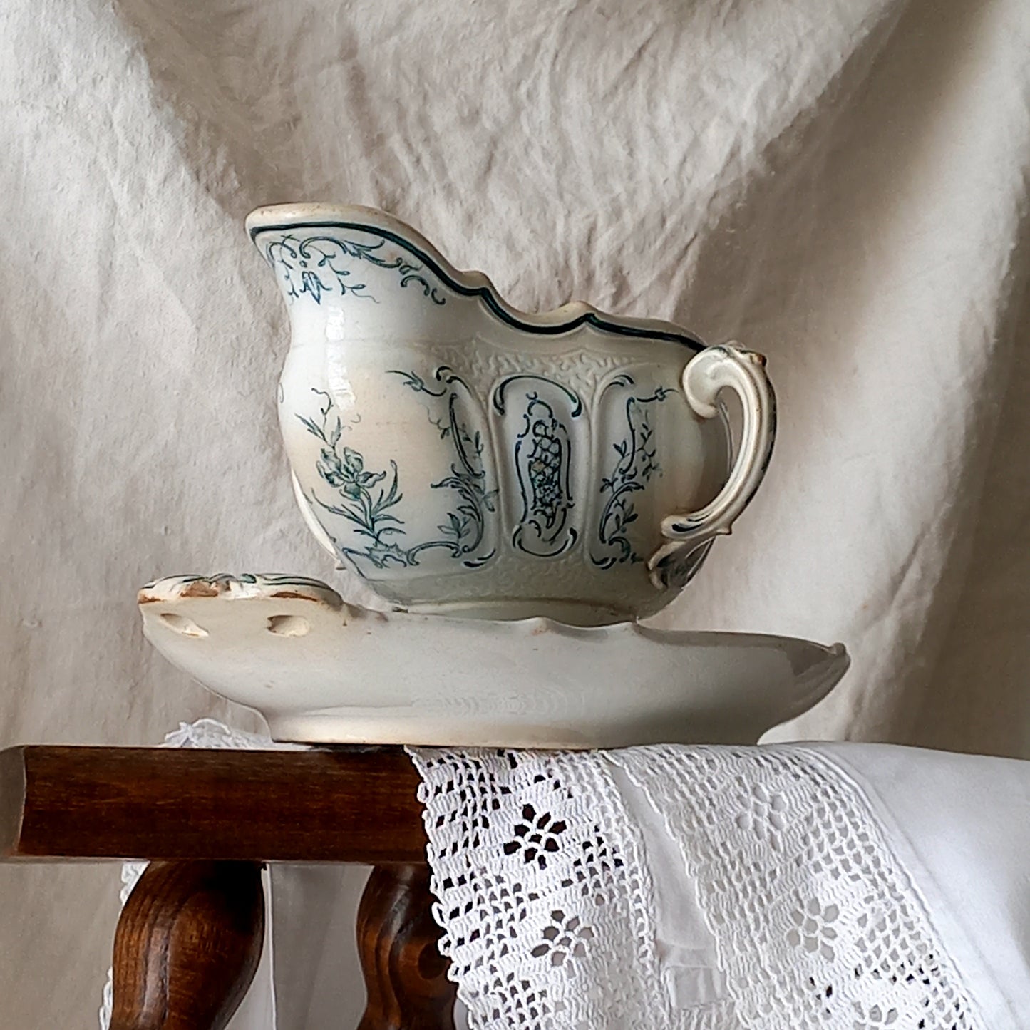 A large and elegant antique ironstone sauce boat with a green floral transferware pattern, a grand-looking, heavy piece. These days this piece will make an excellent piece of decor in any home, especially those of a country or farmhouse nature.