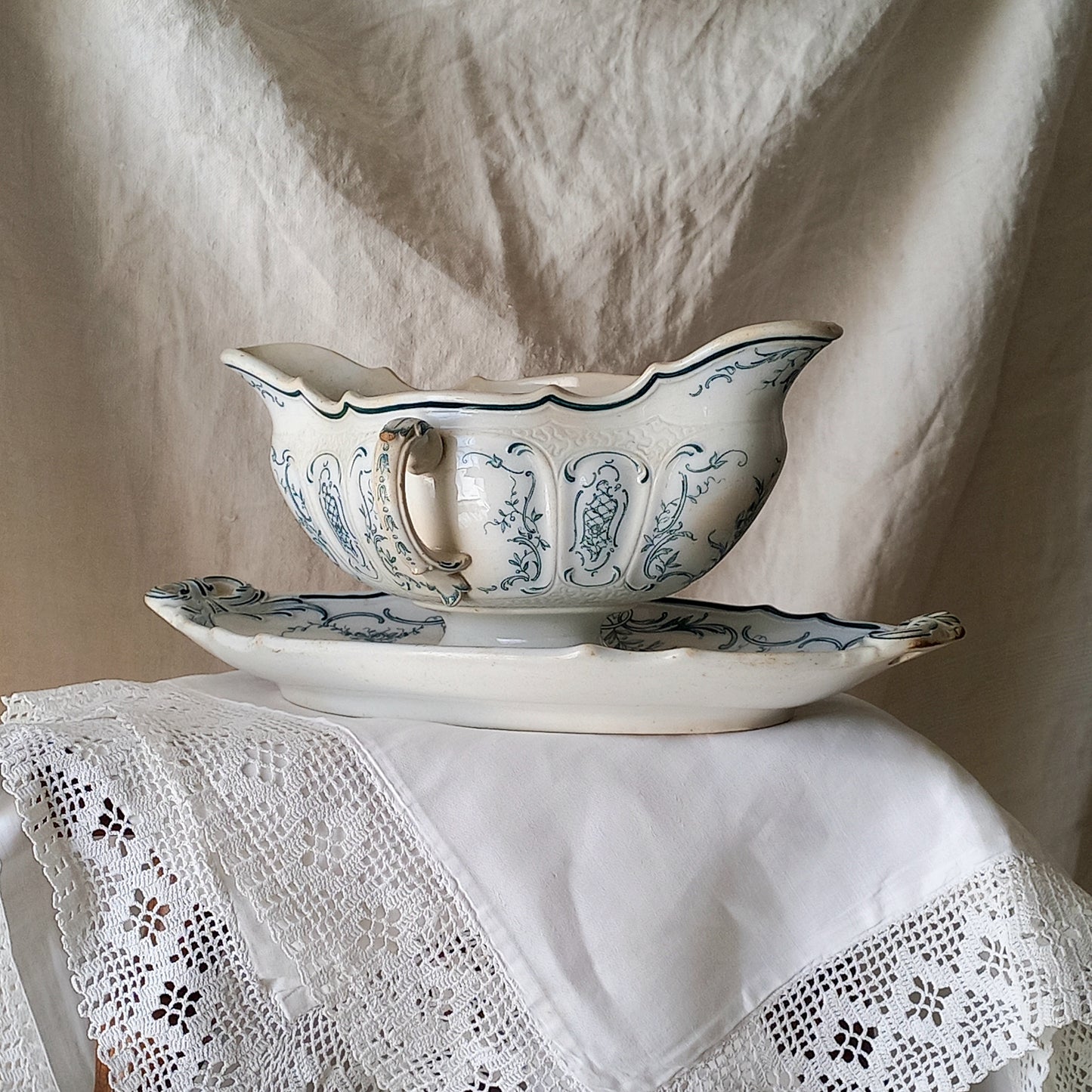 A large and elegant antique ironstone sauce boat with a green floral transferware pattern, a grand-looking, heavy piece. These days this piece will make an excellent piece of decor in any home, especially those of a country or farmhouse nature.