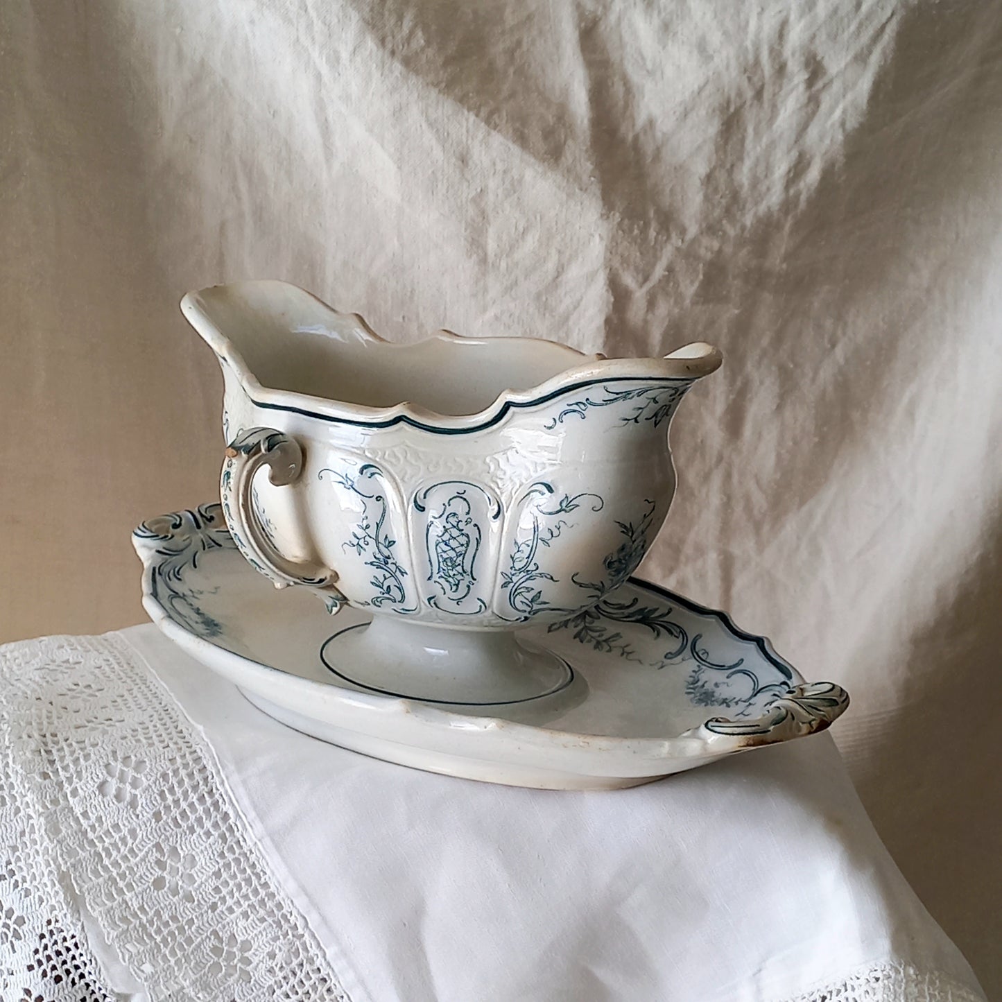 A large and elegant antique ironstone sauce boat with a green floral transferware pattern, a grand-looking, heavy piece. These days this piece will make an excellent piece of decor in any home, especially those of a country or farmhouse nature.