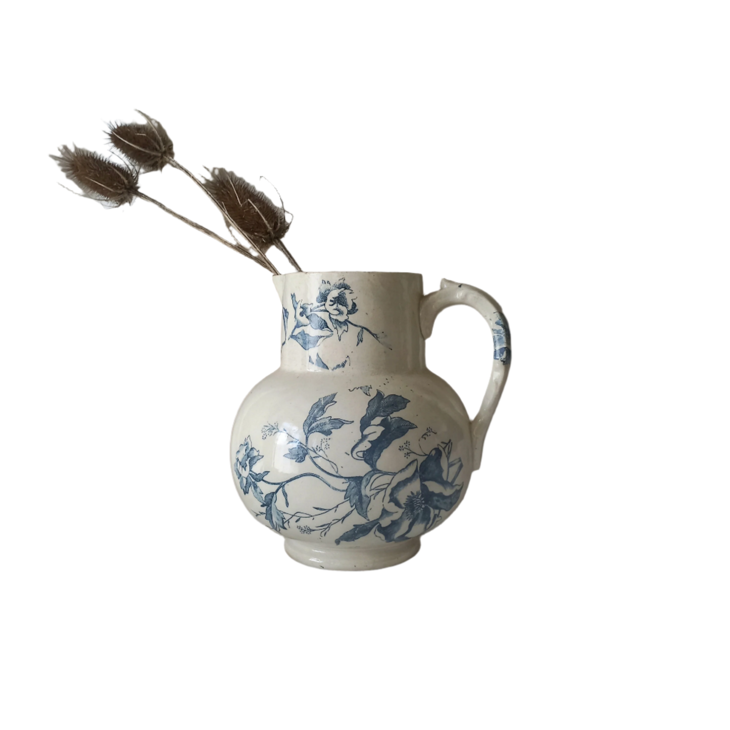 A large and beautiful French antique ironstone jug in a lovely aged white with blue floral transfer pattern. This wonderful piece of ironstone history has a super patina of age that gives it that look we all admire.