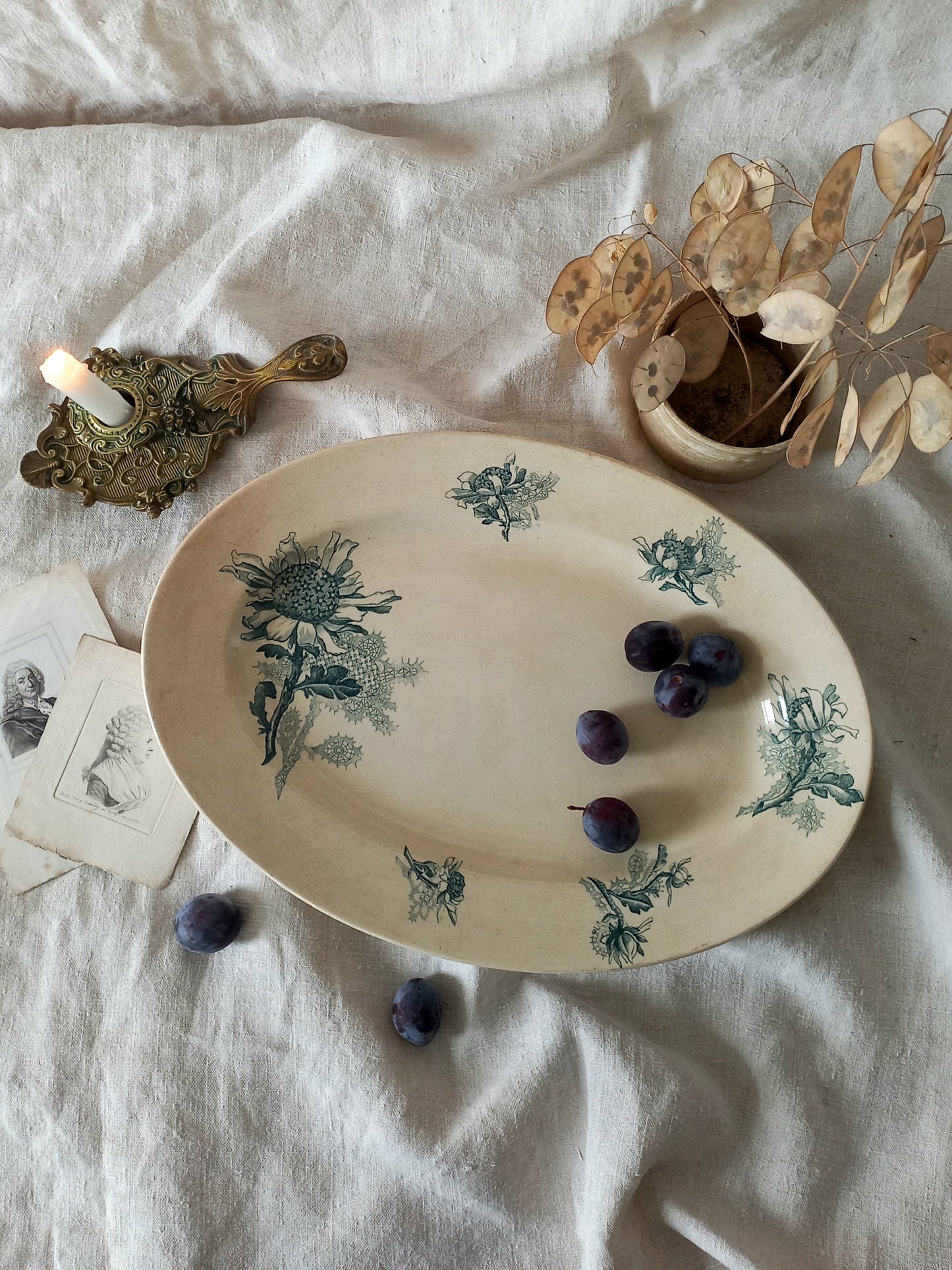 French antique oval ironstone serving plate with teal colour sunflower transferware pattern that over many decades has become a pleasing, warm shade of creamy white with crazing and tea-staining.