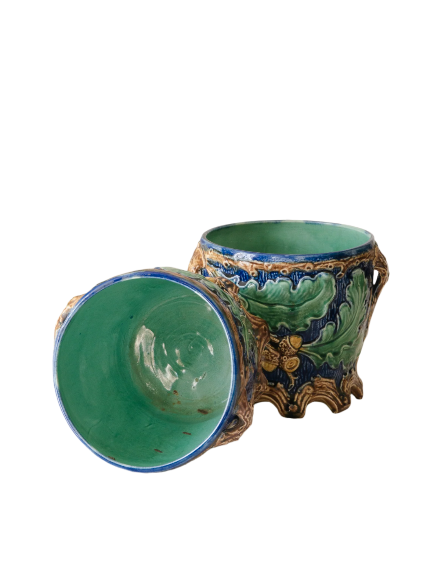 A stunning pair of French antique majolica planters, absolutely glorious fresh blue and green colours with oak leafs and acorns in relief making these stunning pieces of interior home decor wherever you decide to display them.
One of the planters has an antique repair in the form of metal staples that have been expertly done from the inside - in the 1800s and early 1900s this was quite a common repair to have made on items of high value and we feel it only adds to the authenticity/story of these pieces.