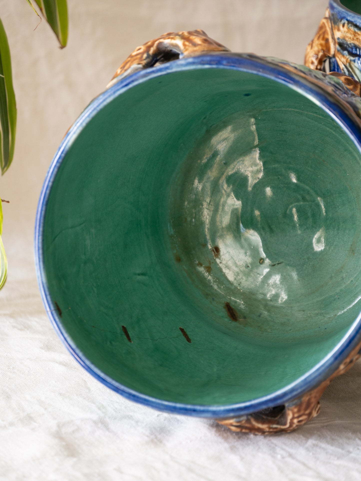 A stunning pair of French antique majolica planters, absolutely glorious fresh blue and green colours with oak leafs and acorns in relief making these stunning pieces of interior home decor wherever you decide to display them.
One of the planters has an antique repair in the form of metal staples that have been expertly done from the inside - in the 1800s and early 1900s this was quite a common repair to have made on items of high value and we feel it only adds to the authenticity/story of these pieces.