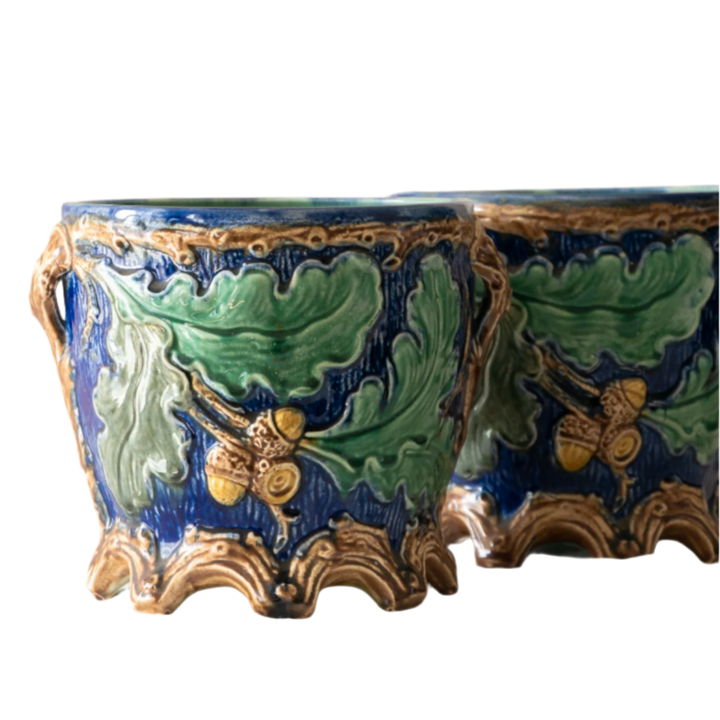 A stunning pair of French antique majolica planters, absolutely glorious fresh blue and green colours with oak leafs and acorns in relief making these stunning pieces of interior home decor wherever you decide to display them.
One of the planters has an antique repair in the form of metal staples that have been expertly done from the inside - in the 1800s and early 1900s this was quite a common repair to have made on items of high value and we feel it only adds to the authenticity/story of these pieces.