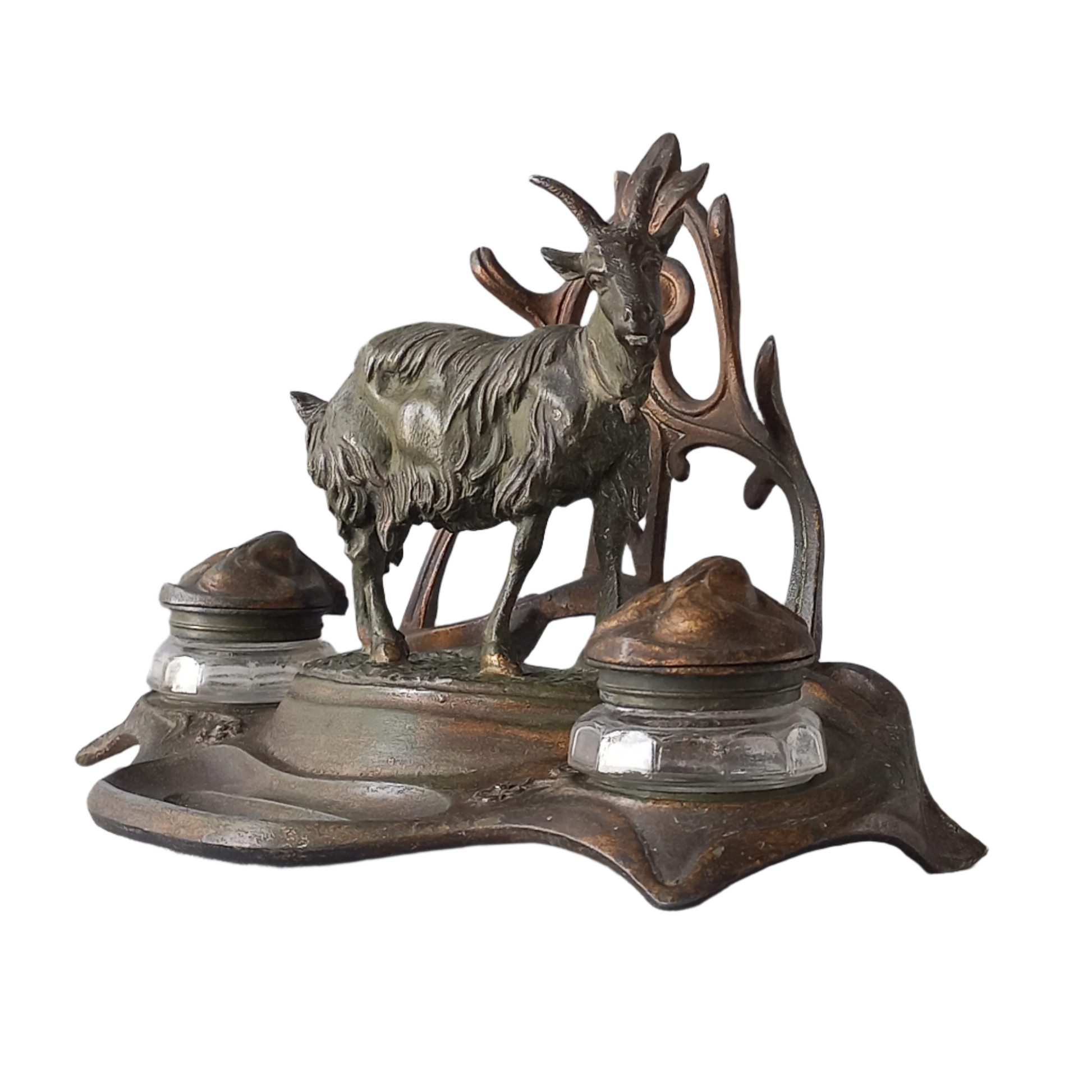 A stunning French art nouveau double inkwell with a goat figurine.
This wonderful antique inkwell has been sculpted in metal and signed by the artist (see photos). Behind the beautiful goat figurine are two pen rests and either side of the goat are two small glass ink pots with decorative metal lids.
The metal is finished in a lovely shade of green that has worn over time with traces of gold colour beneath - it has a wonderful patina of time all over it.