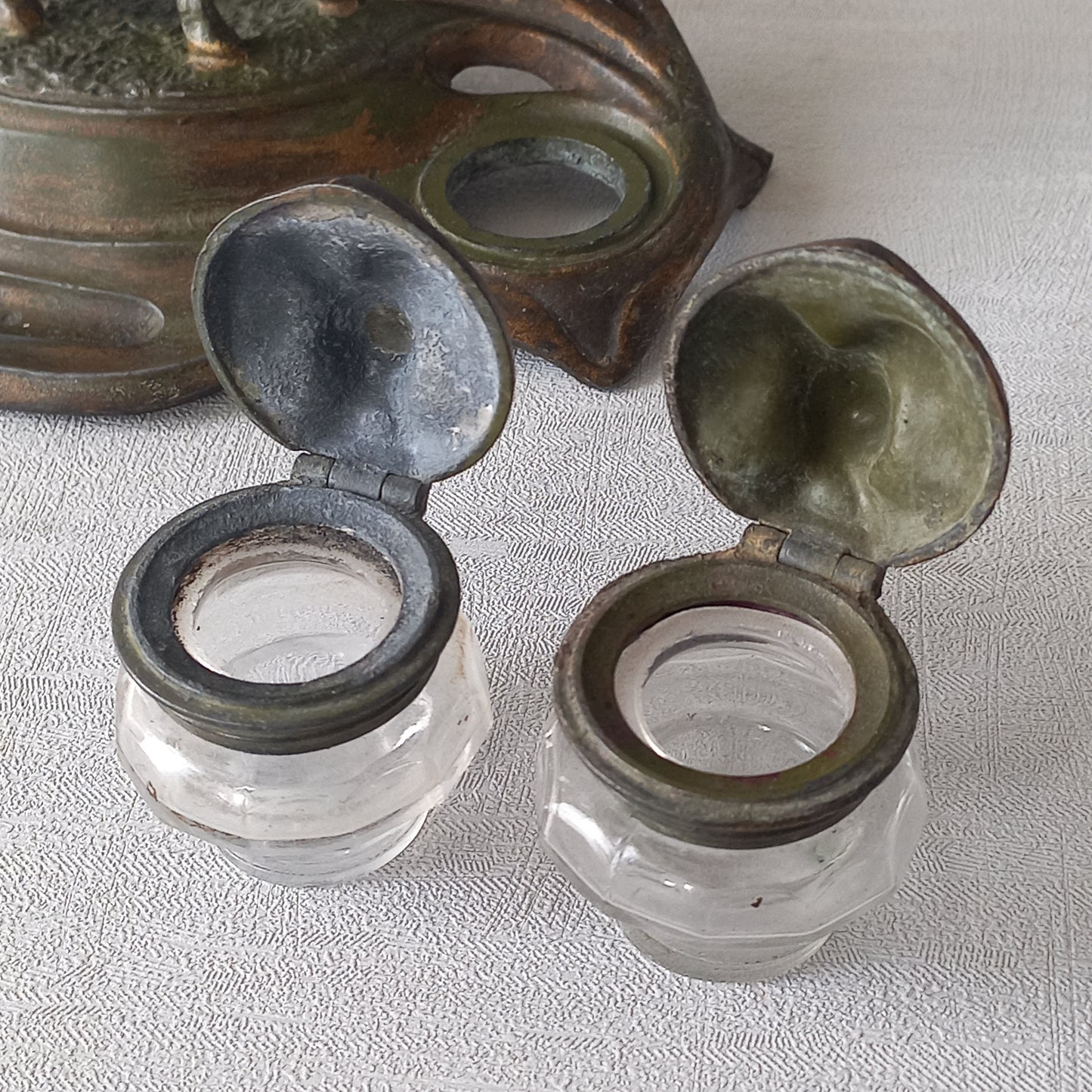 A stunning French art nouveau double inkwell with a goat figurine.
This wonderful antique inkwell has been sculpted in metal and signed by the artist (see photos). Behind the beautiful goat figurine are two pen rests and either side of the goat are two small glass ink pots with decorative metal lids.
The metal is finished in a lovely shade of green that has worn over time with traces of gold colour beneath - it has a wonderful patina of time all over it.