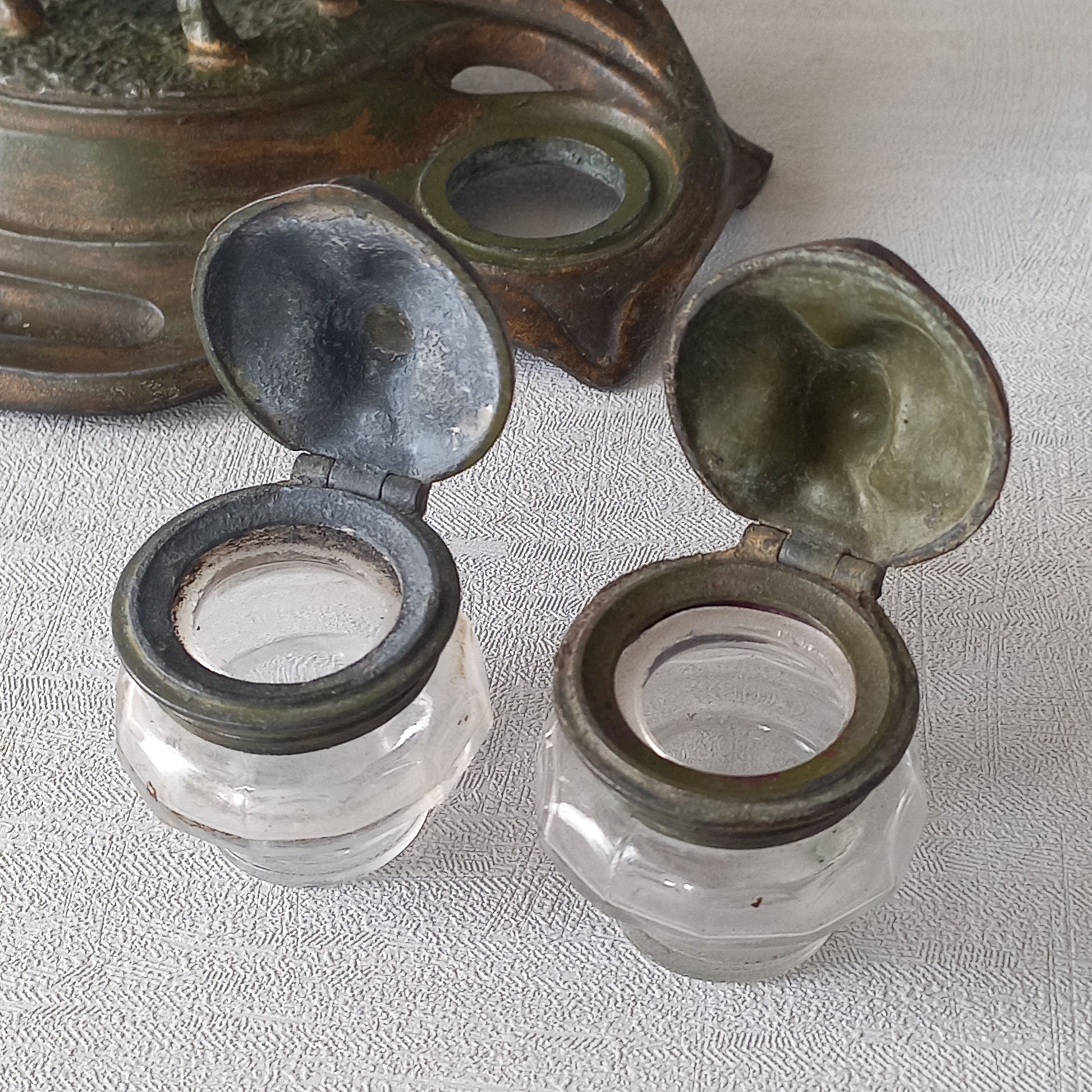 A stunning French art nouveau double inkwell with a goat figurine.
This wonderful antique inkwell has been sculpted in metal and signed by the artist (see photos). Behind the beautiful goat figurine are two pen rests and either side of the goat are two small glass ink pots with decorative metal lids.
The metal is finished in a lovely shade of green that has worn over time with traces of gold colour beneath - it has a wonderful patina of time all over it.