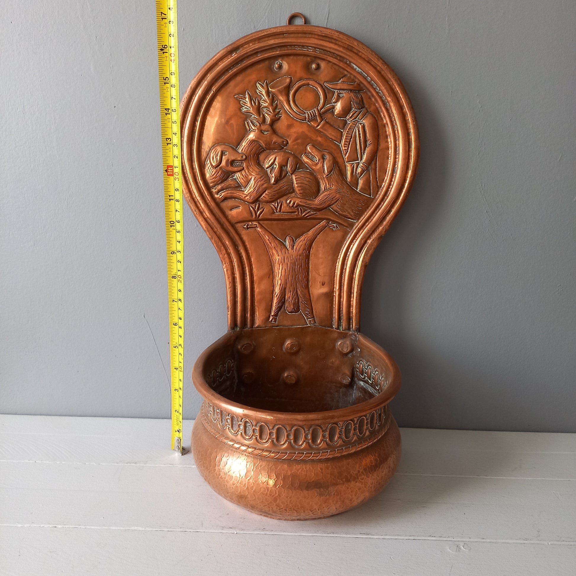 A very handsome copper vintage/antique wall-mounted planter with a hunting scene that I purchased in south west France.
This wonderful rustic piece may at some time have had another purpose, although being a planter seems to suit it just perfectly. There is a hanging hook to the rear, although it can also be displayed sitting on a flat surface as it's depicted in my photos - it's very interesting that we can also see the crude yet charming way this heavy copper planter was constructed by the artisan.