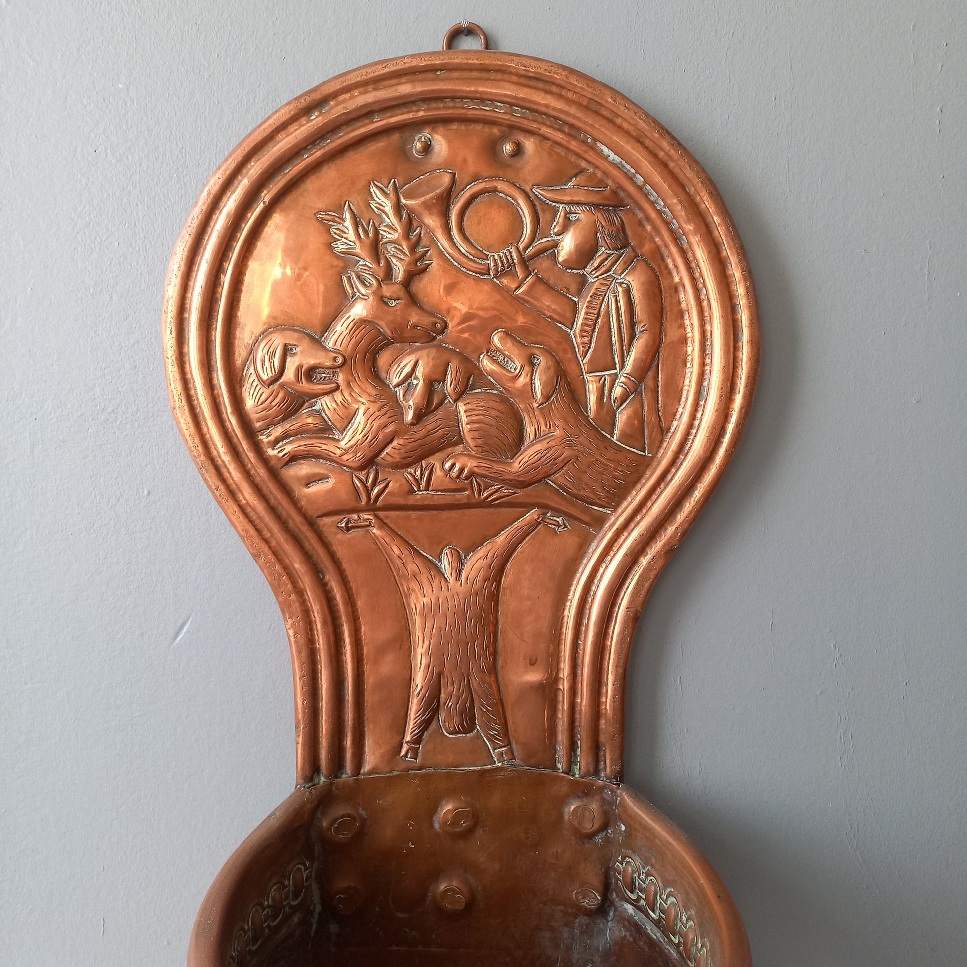 A very handsome copper vintage/antique wall-mounted planter with a hunting scene that I purchased in south west France.
This wonderful rustic piece may at some time have had another purpose, although being a planter seems to suit it just perfectly. There is a hanging hook to the rear, although it can also be displayed sitting on a flat surface as it's depicted in my photos - it's very interesting that we can also see the crude yet charming way this heavy copper planter was constructed by the artisan.