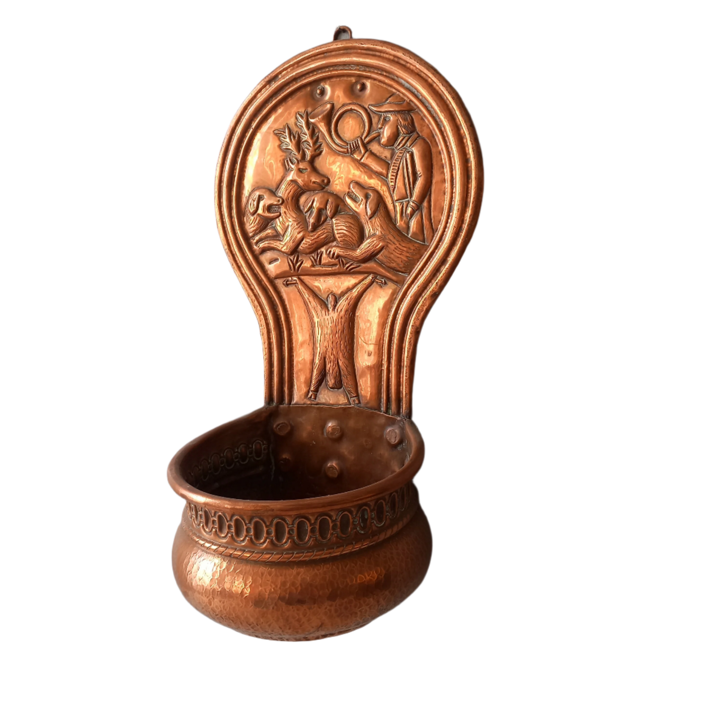 A very handsome copper vintage/antique wall-mounted planter with a hunting scene that I purchased in south west France.
This wonderful rustic piece may at some time have had another purpose, although being a planter seems to suit it just perfectly. There is a hanging hook to the rear, although it can also be displayed sitting on a flat surface as it's depicted in my photos - it's very interesting that we can also see the crude yet charming way this heavy copper planter was constructed by the artisan.