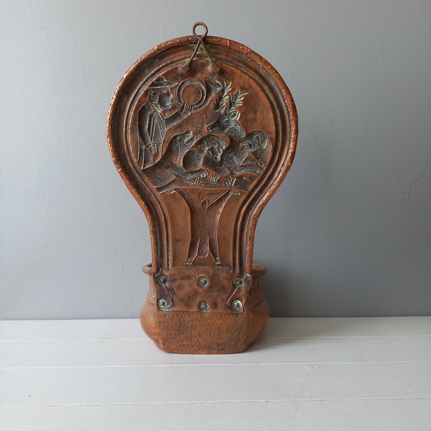 A very handsome copper vintage/antique wall-mounted planter with a hunting scene that I purchased in south west France.
This wonderful rustic piece may at some time have had another purpose, although being a planter seems to suit it just perfectly. There is a hanging hook to the rear, although it can also be displayed sitting on a flat surface as it's depicted in my photos - it's very interesting that we can also see the crude yet charming way this heavy copper planter was constructed by the artisan.