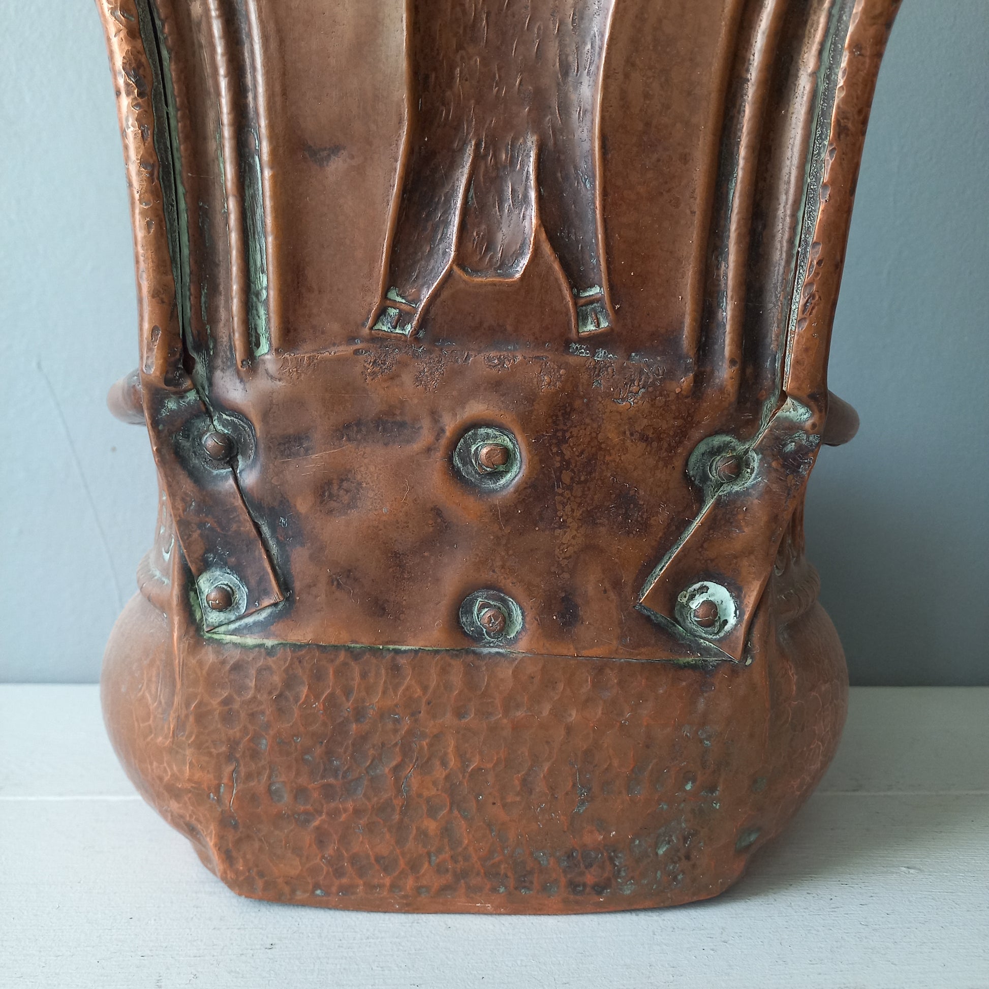 A very handsome copper vintage/antique wall-mounted planter with a hunting scene that I purchased in south west France.
This wonderful rustic piece may at some time have had another purpose, although being a planter seems to suit it just perfectly. There is a hanging hook to the rear, although it can also be displayed sitting on a flat surface as it's depicted in my photos - it's very interesting that we can also see the crude yet charming way this heavy copper planter was constructed by the artisan.