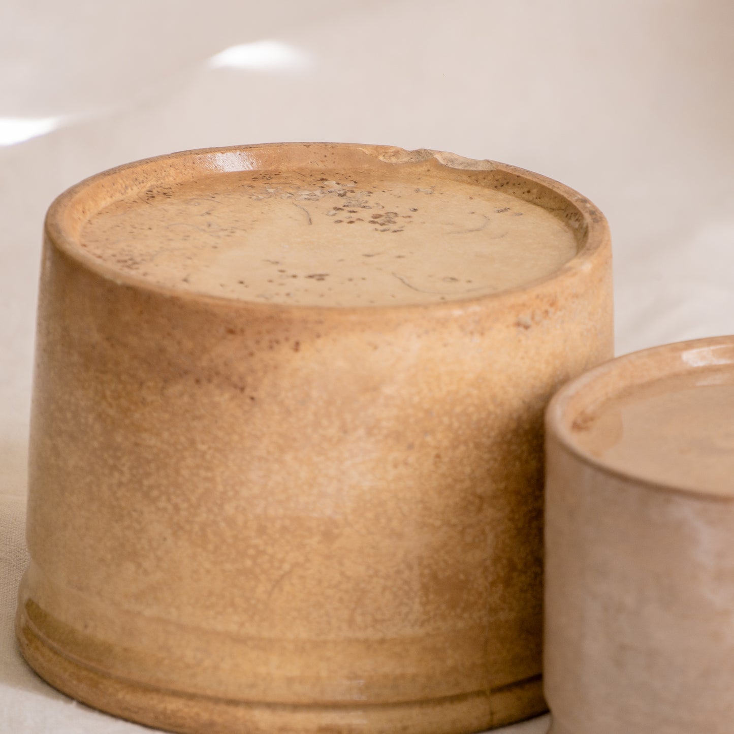 A pair of French antique tea-stained white to creamy brown ironstone crock pots or preserve pots.
In the past these small pots were quintessential pieces in French kitchens for storing jam, etc, and these days are still just as useful for items such as utensils.
Smaller pot was manufactured by Choisy le Roi, circa. late 1800s. The larger pot has no maker's mark - circa. late 1800s/early 1900s.