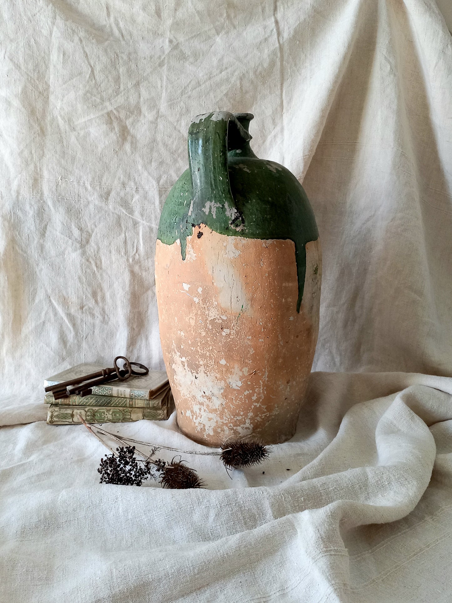 A rare and very large French antique stoneware preserving jar in a lovely shade of green over an earthy beige.