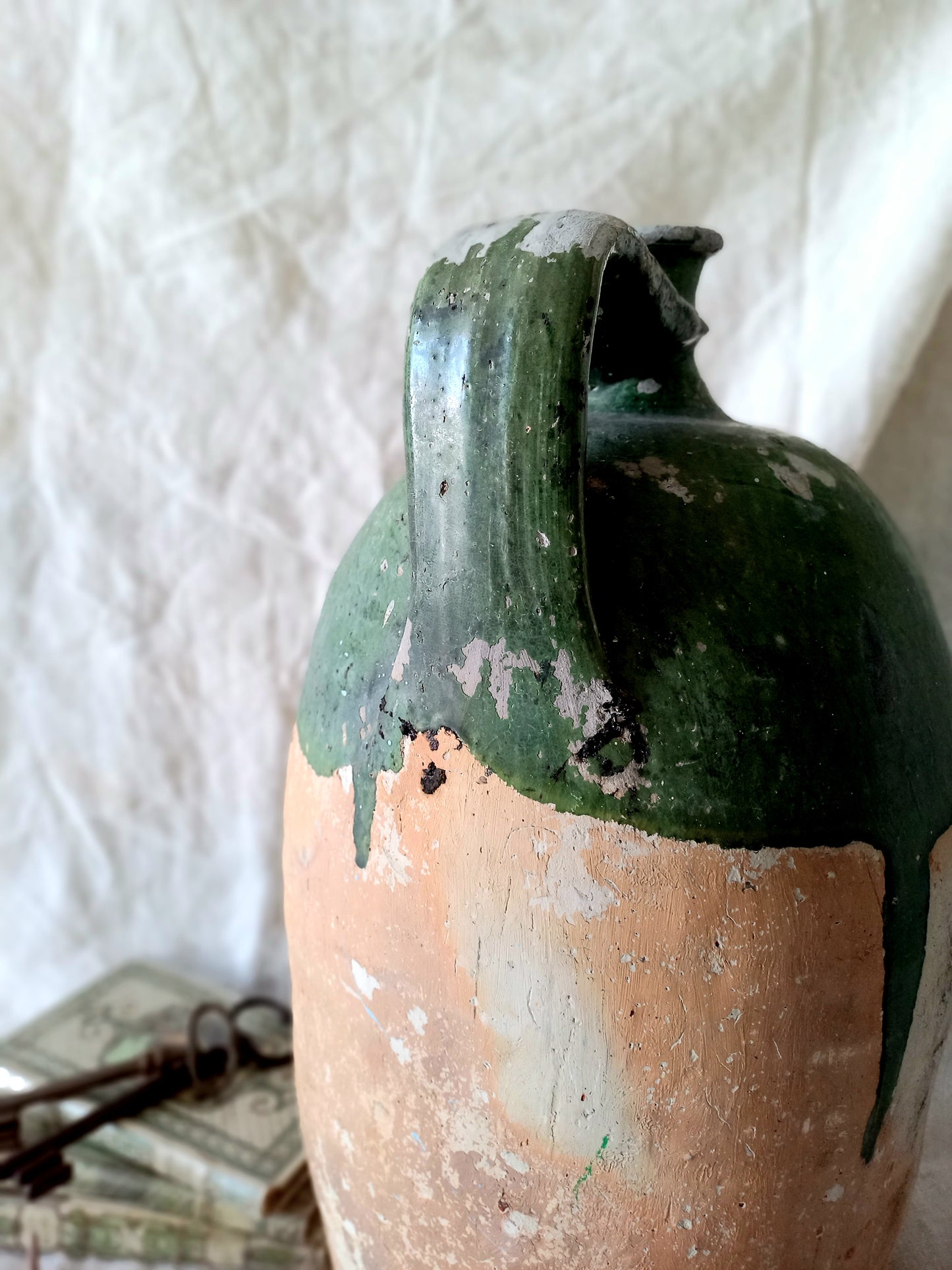 A rare and very large French antique stoneware preserving jar in a lovely shade of green over an earthy beige.