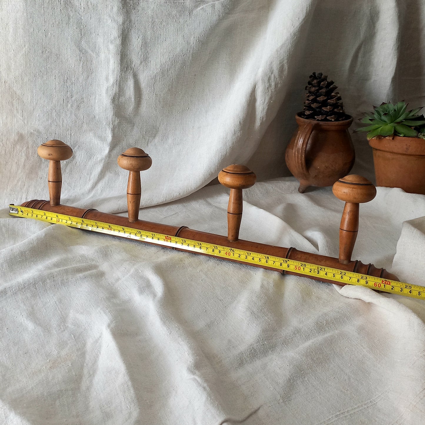 A French vintage faux bamboo wooden coat rack with 4 hanging hooks/pegs. These older type of faux bamboo coat racks are becoming increasingly difficult to source, especially in this excellent condition! There are two metal hanging hooks to the rear for mounting to your wall.
In summary, a wonderful piece of wall decor for any interior, and especially those of a country home, rustic or farmhouse style.