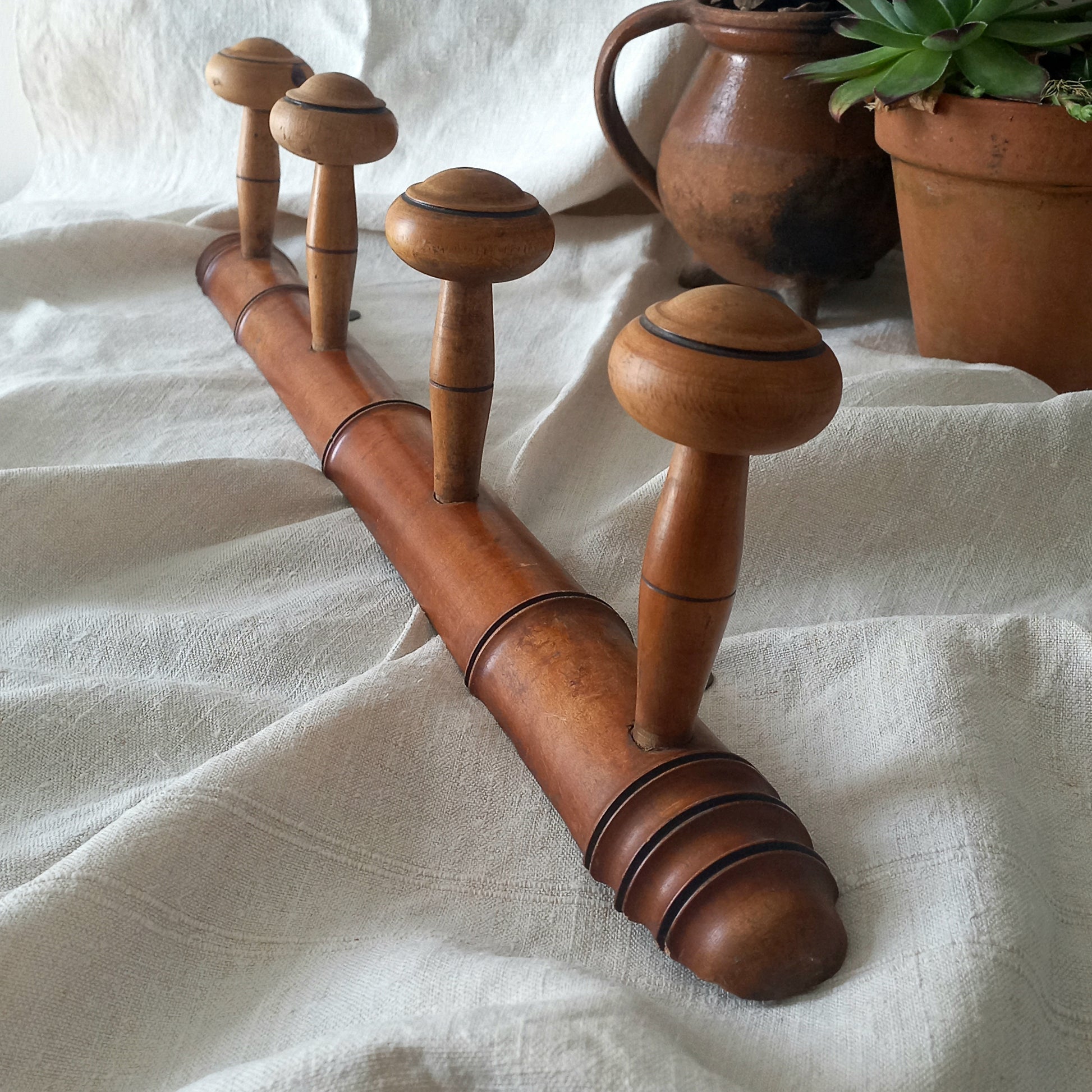 A French vintage faux bamboo wooden coat rack with 4 hanging hooks/pegs. These older type of faux bamboo coat racks are becoming increasingly difficult to source, especially in this excellent condition! There are two metal hanging hooks to the rear for mounting to your wall.
In summary, a wonderful piece of wall decor for any interior, and especially those of a country home, rustic or farmhouse style.