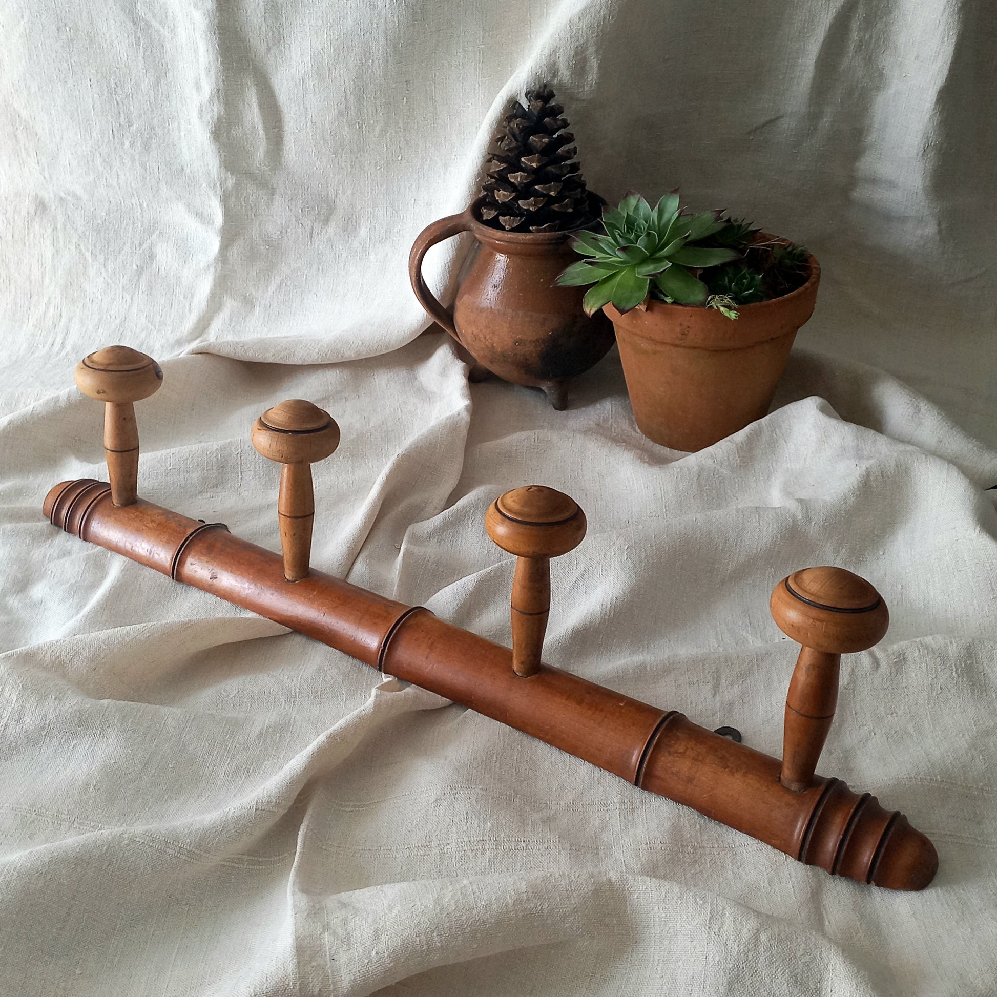 A French vintage faux bamboo wooden coat rack with 4 hanging hooks/pegs. These older type of faux bamboo coat racks are becoming increasingly difficult to source, especially in this excellent condition! There are two metal hanging hooks to the rear for mounting to your wall.
In summary, a wonderful piece of wall decor for any interior, and especially those of a country home, rustic or farmhouse style.