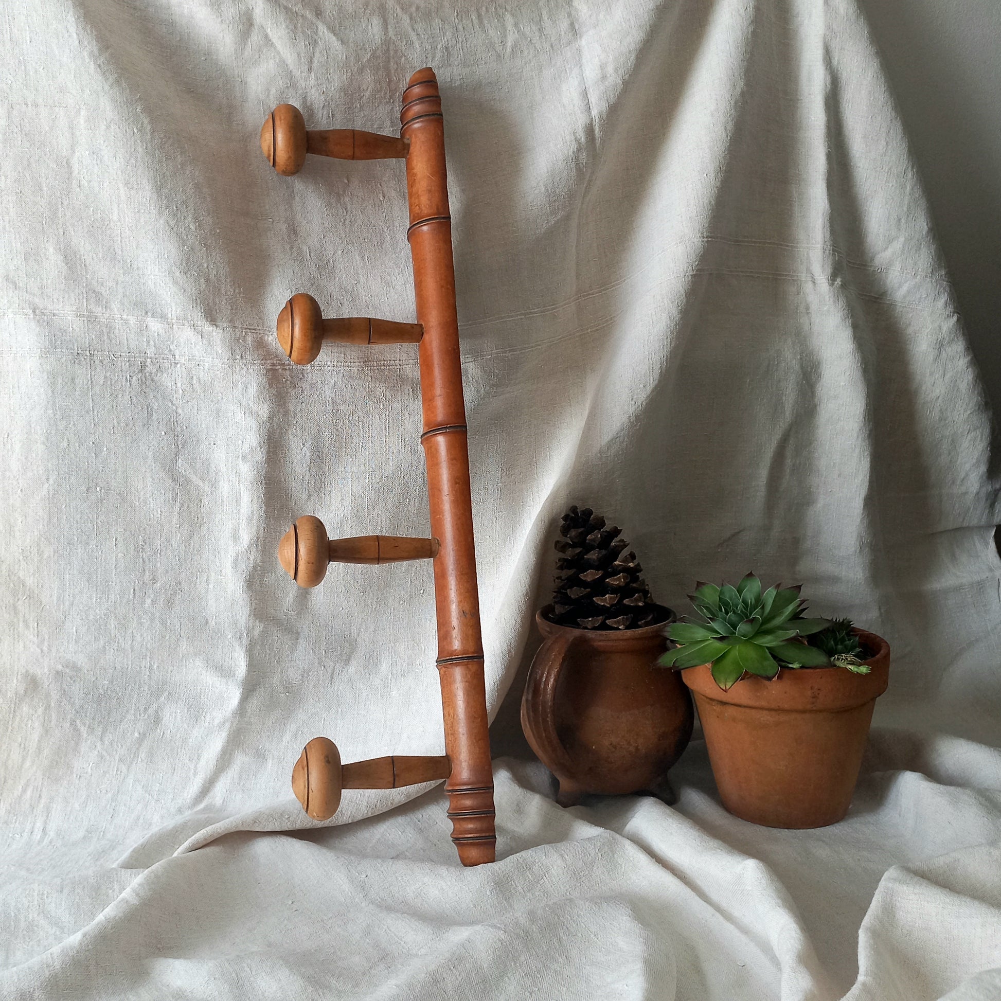 A French vintage faux bamboo wooden coat rack with 4 hanging hooks/pegs. These older type of faux bamboo coat racks are becoming increasingly difficult to source, especially in this excellent condition! There are two metal hanging hooks to the rear for mounting to your wall.
In summary, a wonderful piece of wall decor for any interior, and especially those of a country home, rustic or farmhouse style.