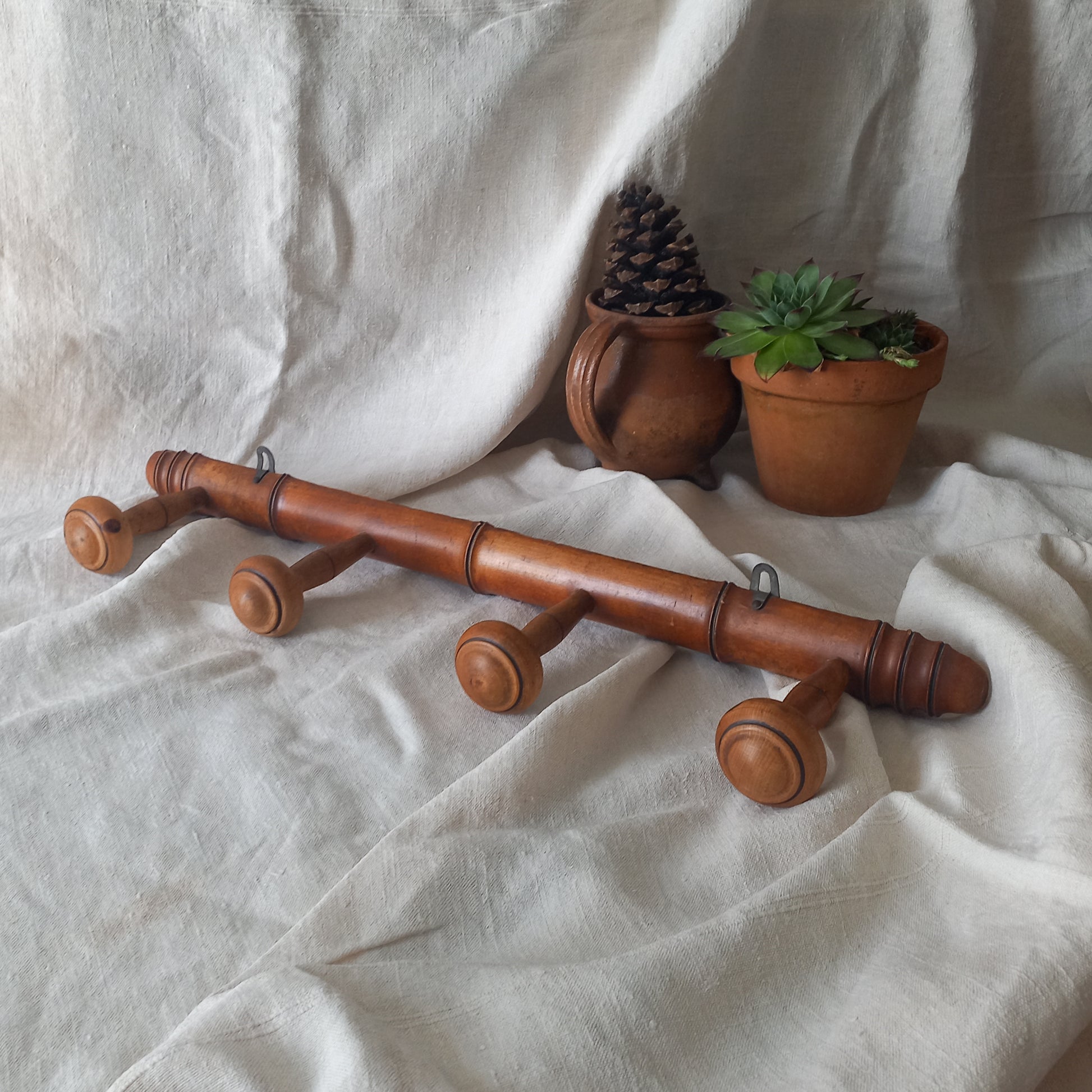 A French vintage faux bamboo wooden coat rack with 4 hanging hooks/pegs. These older type of faux bamboo coat racks are becoming increasingly difficult to source, especially in this excellent condition! There are two metal hanging hooks to the rear for mounting to your wall.
In summary, a wonderful piece of wall decor for any interior, and especially those of a country home, rustic or farmhouse style.