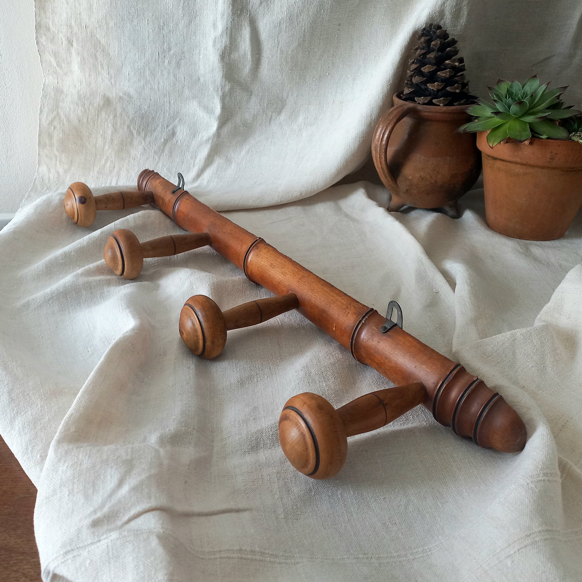 A French vintage faux bamboo wooden coat rack with 4 hanging hooks/pegs. These older type of faux bamboo coat racks are becoming increasingly difficult to source, especially in this excellent condition! There are two metal hanging hooks to the rear for mounting to your wall.
In summary, a wonderful piece of wall decor for any interior, and especially those of a country home, rustic or farmhouse style.