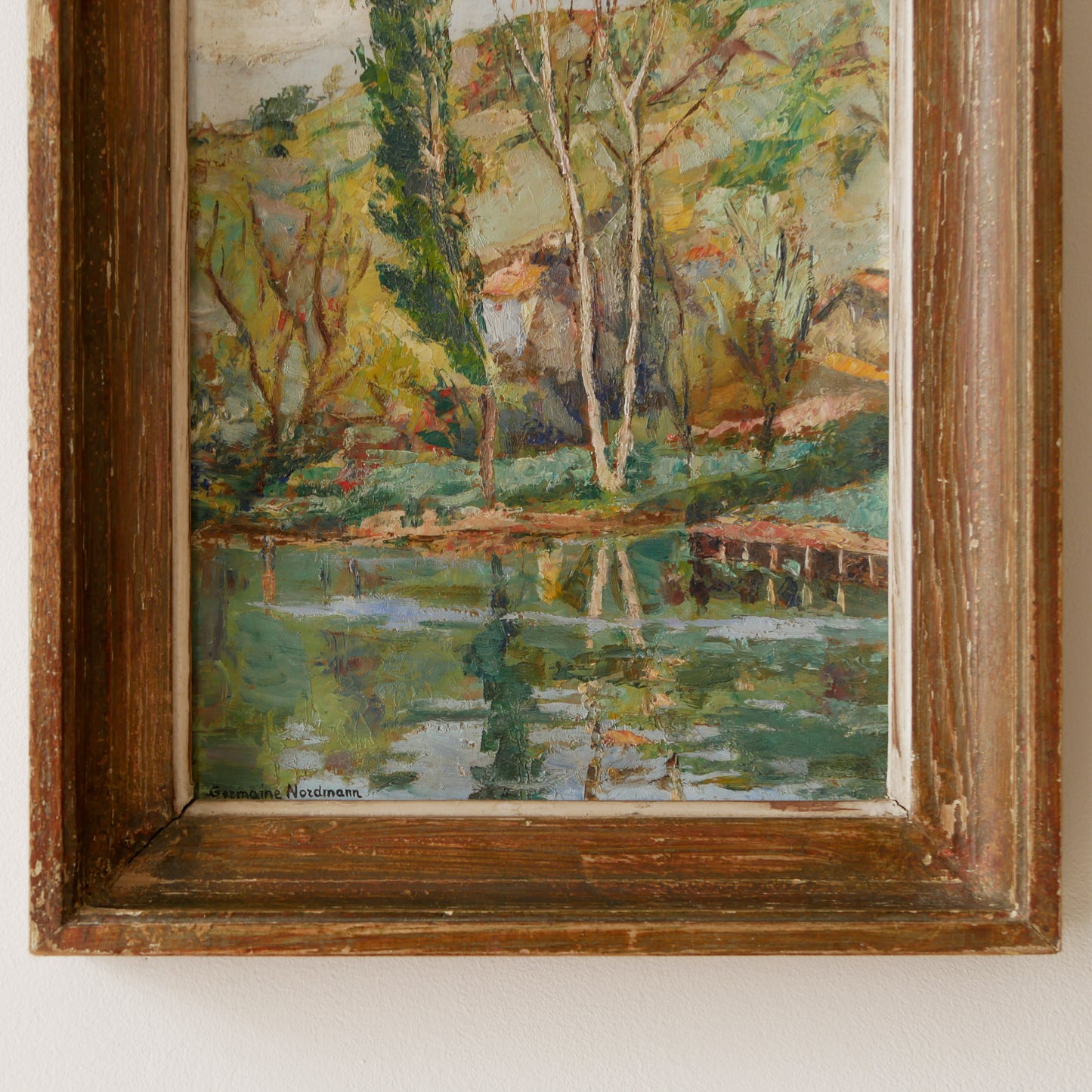 An original vintage landscape oil painting depicting a charming country home in among a wooded area with hills in the background. In the foreground a gentle river reflects the trees in the background.
The painting has been painted by an experienced artist with confident brush strokes - a really wonderful piece of original art.
The painting is presented in an old worn wooden frame which we love and think others will too - it really suits this piece.