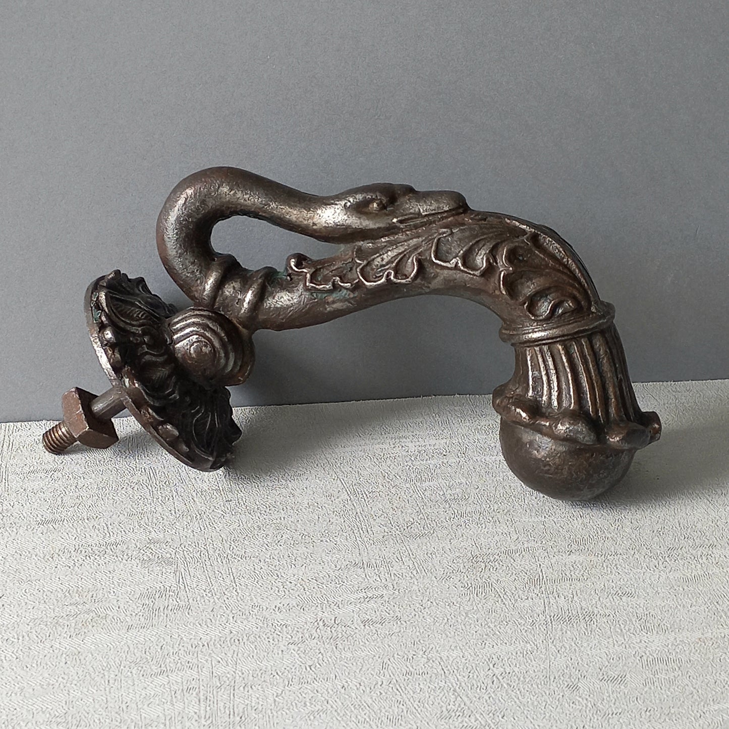 A stunning and large antique cast iron decorative door knocker with an elegant swan's neck and head, a very heavy and original antique piece purchased in south west France.