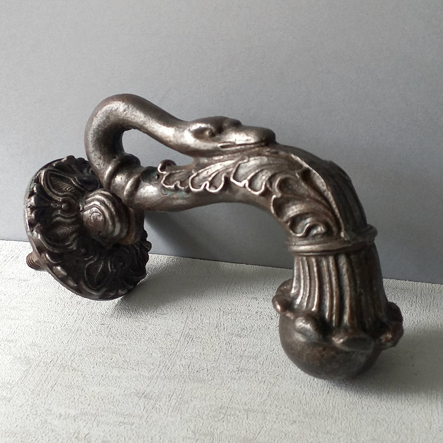 A stunning and large antique cast iron decorative door knocker with an elegant swan's neck and head, a very heavy and original antique piece purchased in south west France.