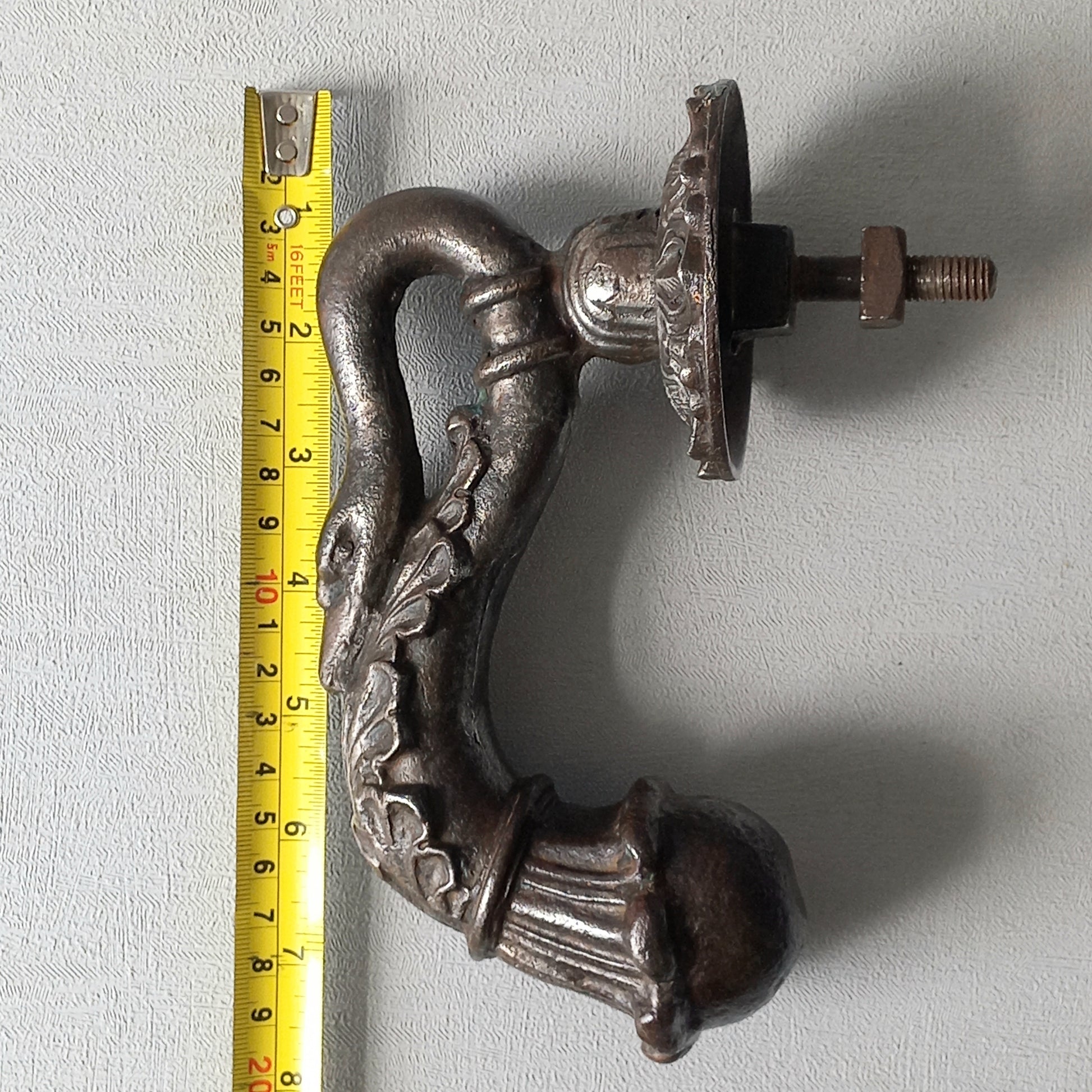 A stunning and large antique cast iron decorative door knocker with an elegant swan's neck and head, a very heavy and original antique piece purchased in south west France.