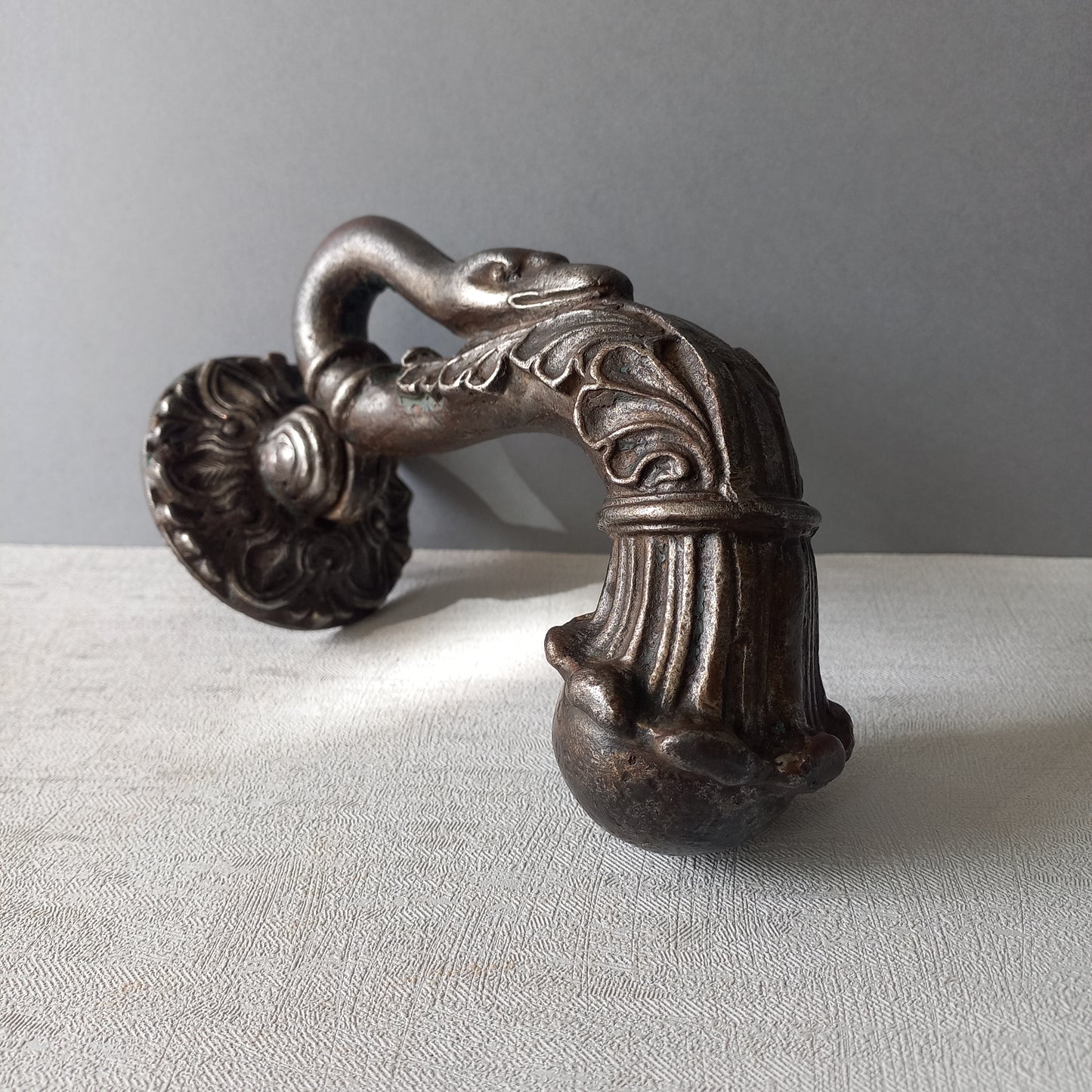 A stunning and large antique cast iron decorative door knocker with an elegant swan's neck and head, a very heavy and original antique piece purchased in south west France.