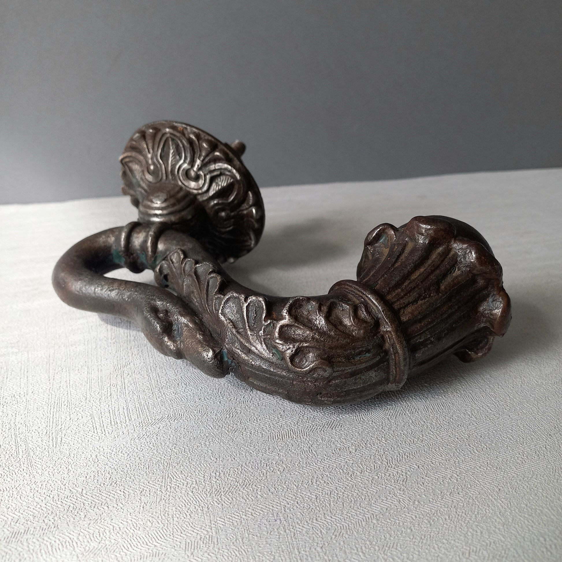 A stunning and large antique cast iron decorative door knocker with an elegant swan's neck and head, a very heavy and original antique piece purchased in south west France.