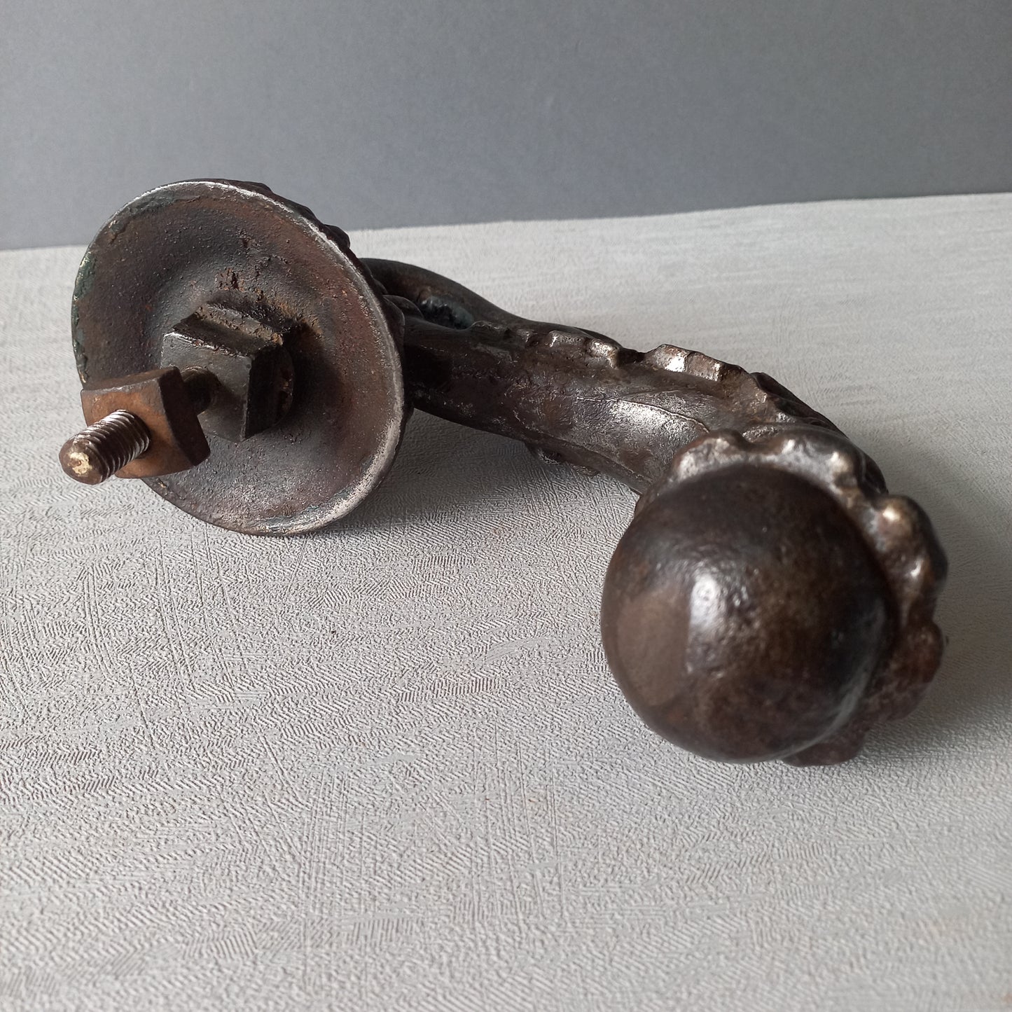 A stunning and large antique cast iron decorative door knocker with an elegant swan's neck and head, a very heavy and original antique piece purchased in south west France.