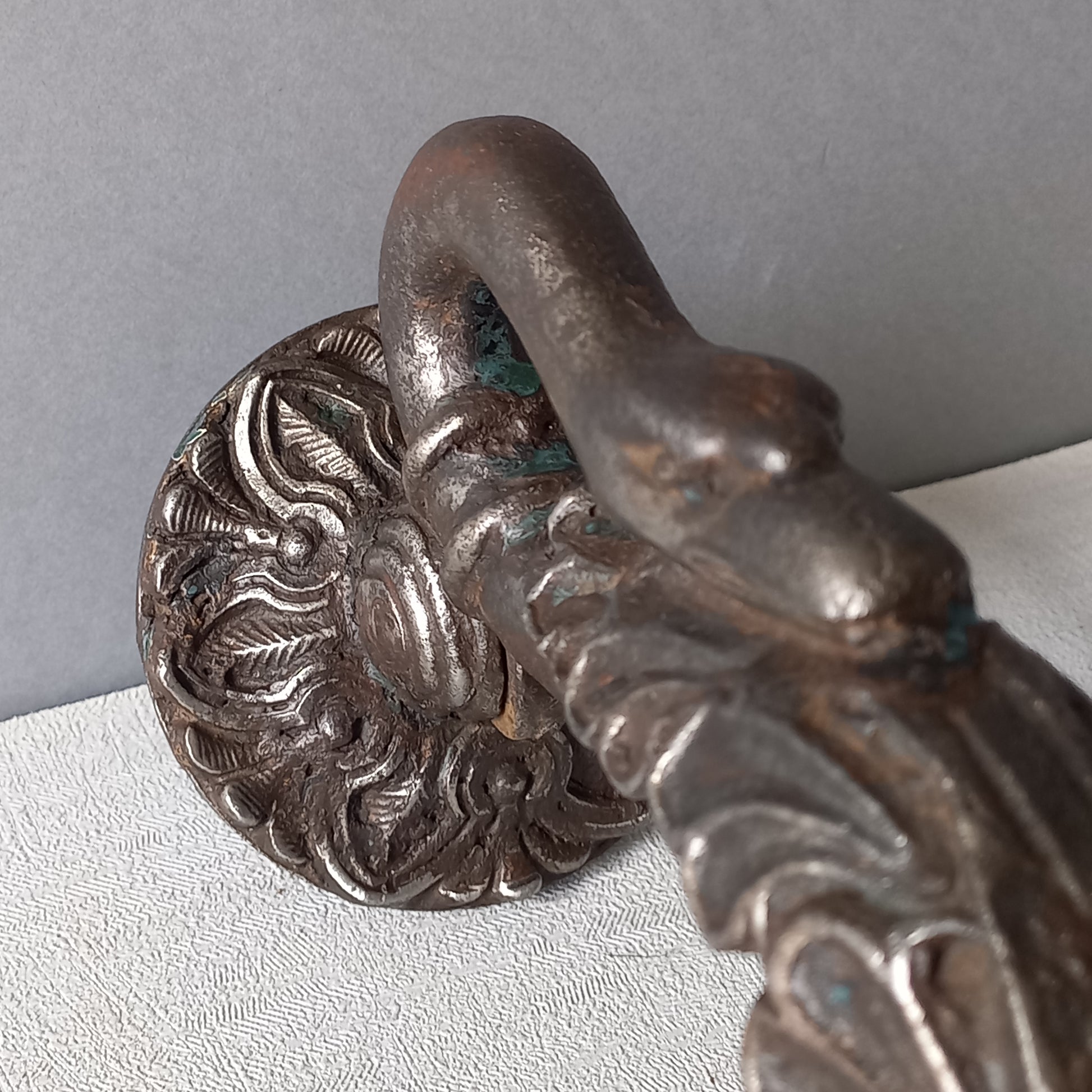 A stunning and large antique cast iron decorative door knocker with an elegant swan's neck and head, a very heavy and original antique piece purchased in south west France.
