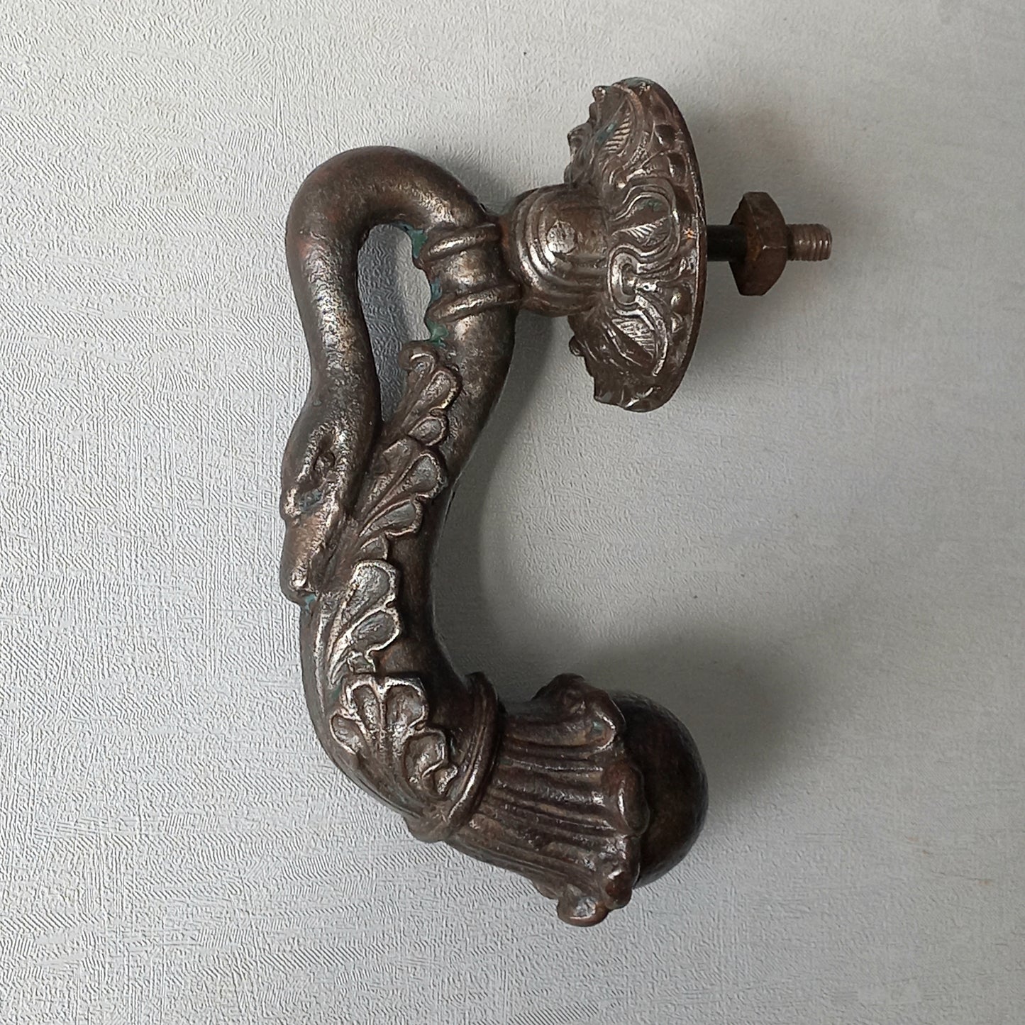 A stunning and large antique cast iron decorative door knocker with an elegant swan's neck and head, a very heavy and original antique piece purchased in south west France.