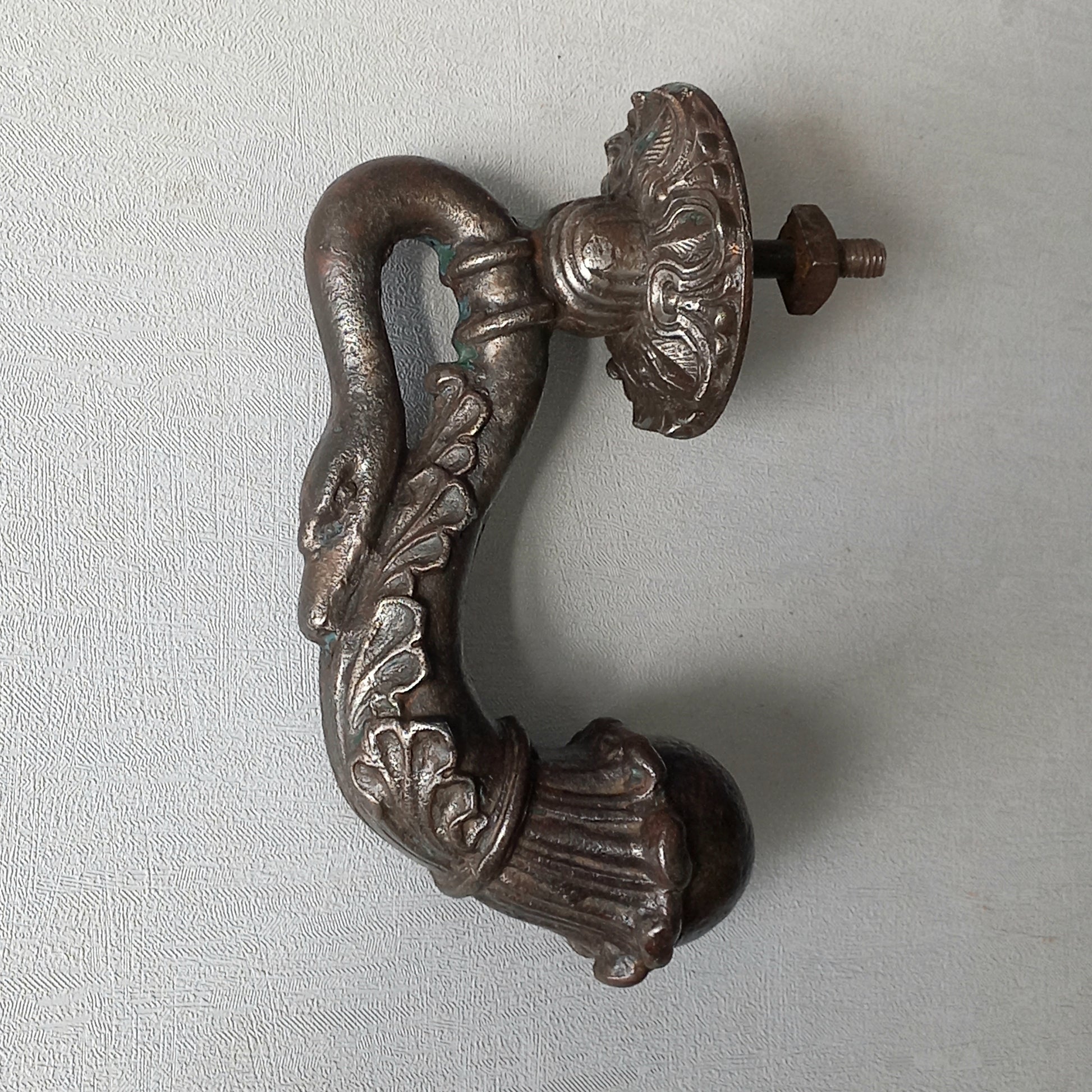 A stunning and large antique cast iron decorative door knocker with an elegant swan's neck and head, a very heavy and original antique piece purchased in south west France.