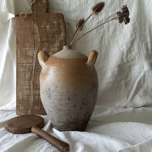A large vintage/antique hand-made stoneware jar once used to store oil - with its wonderful earthy tones these days it will make an eye-catching piece of decor full of rustic charm that offers many decorative possibilities to any interior, particularly those of a country, rustic or farmhouse nature.