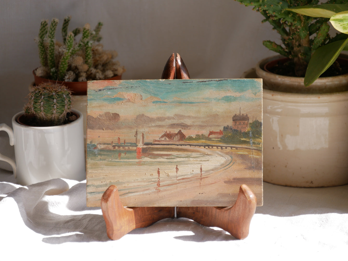 A beautiful pair of small coastal beach paintings on little wooden boards. Each original painting is wonderfully rendered with delightful and moody colours. The artist has signed one painting.
These original pieces of art look great displayed against a wall or on a mantelpiece, etc, and would also look equally nice on miniature easels as seen in two of our photos, or framed and on the wall - many possibilities!