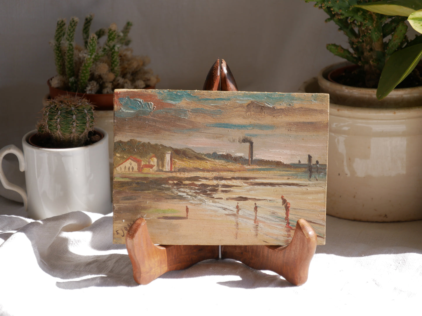 A beautiful pair of small coastal beach paintings on little wooden boards. Each original painting is wonderfully rendered with delightful and moody colours. The artist has signed one painting.
These original pieces of art look great displayed against a wall or on a mantelpiece, etc, and would also look equally nice on miniature easels as seen in two of our photos, or framed and on the wall - many possibilities!
