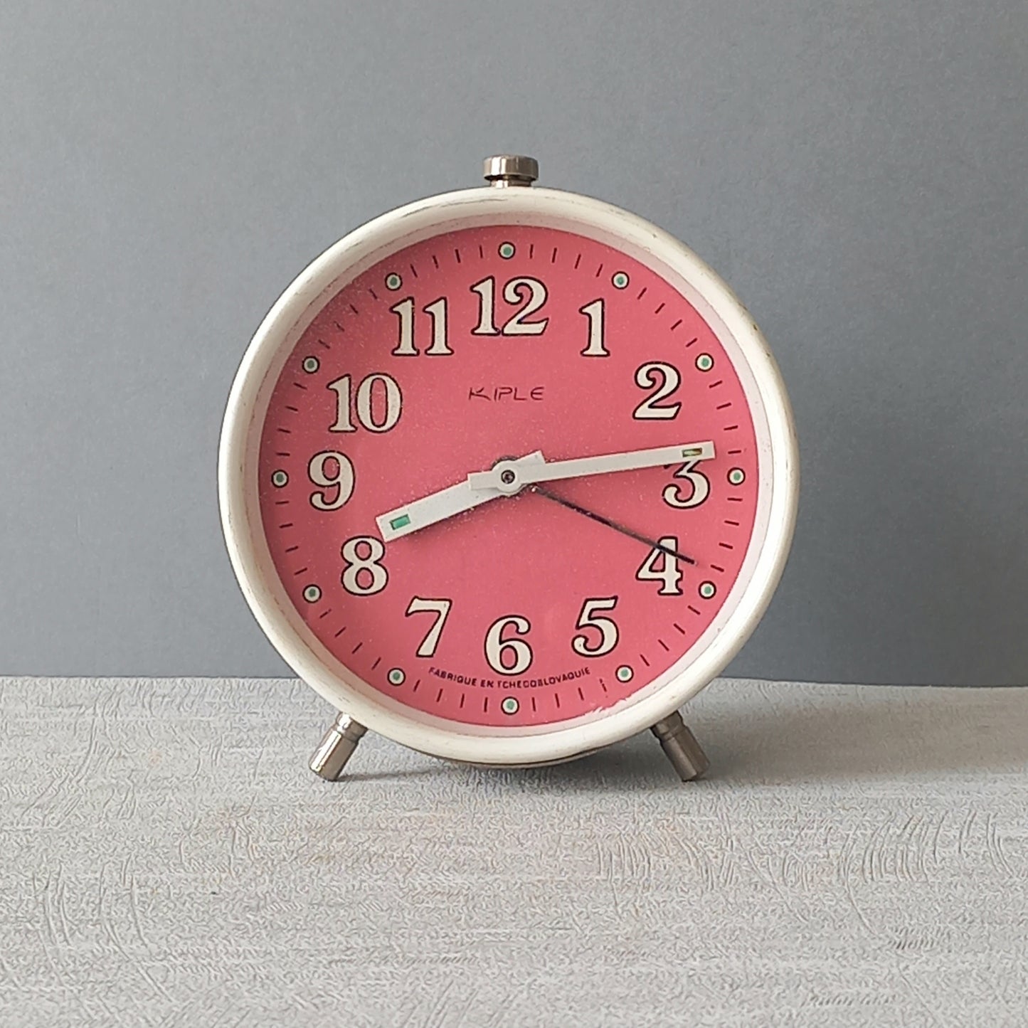 A wonderful vintage alarm clock in an eye-catching white and pink color scheme. This old clock is in working condition including the alarm and has a nice soothing ticking sound too. A great piece of European history from the former country of Czechoslovakia
In summary, a nice vintage alarm clock!
