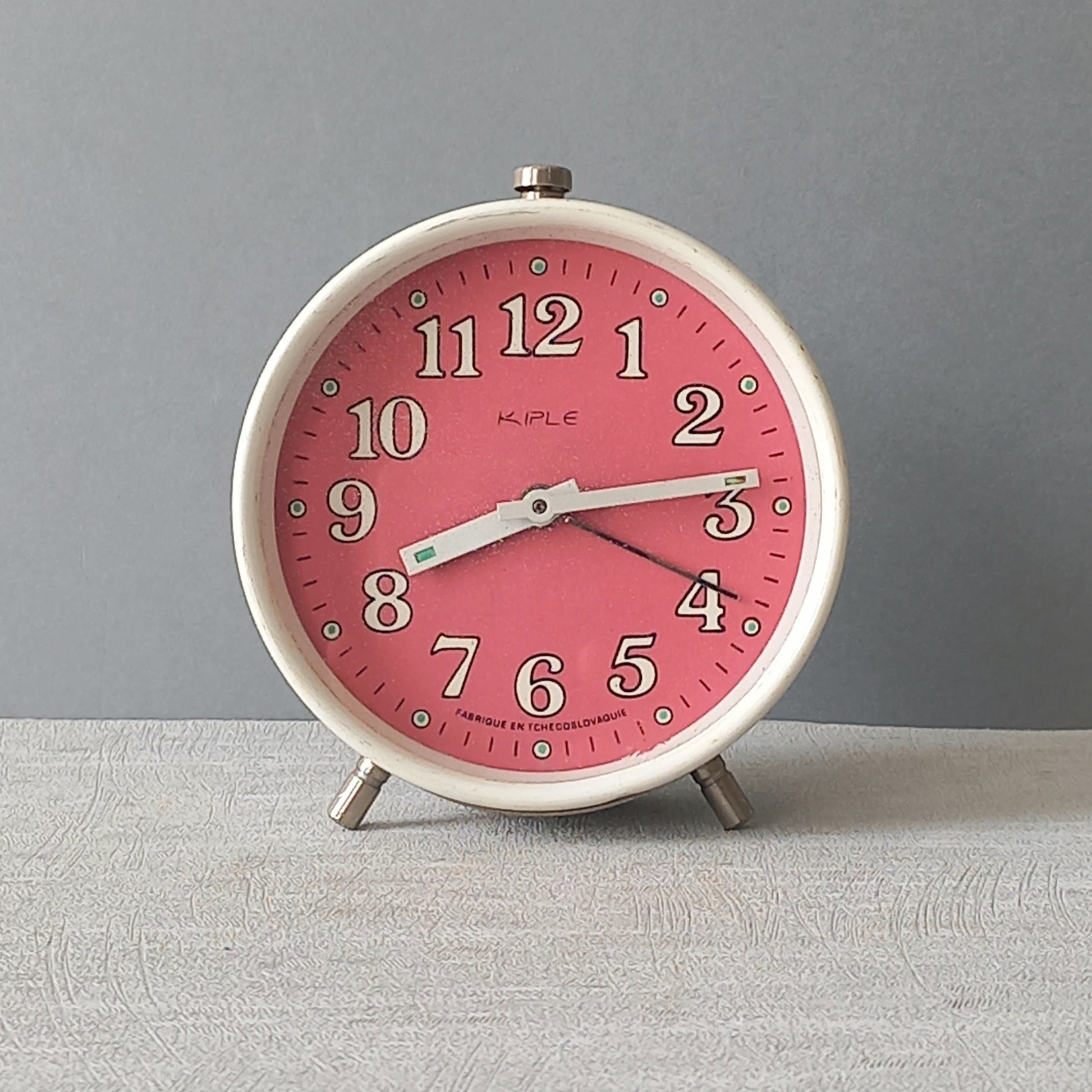 A wonderful vintage alarm clock in an eye-catching white and pink color scheme. This old clock is in working condition including the alarm and has a nice soothing ticking sound too. A great piece of European history from the former country of Czechoslovakia
In summary, a nice vintage alarm clock!