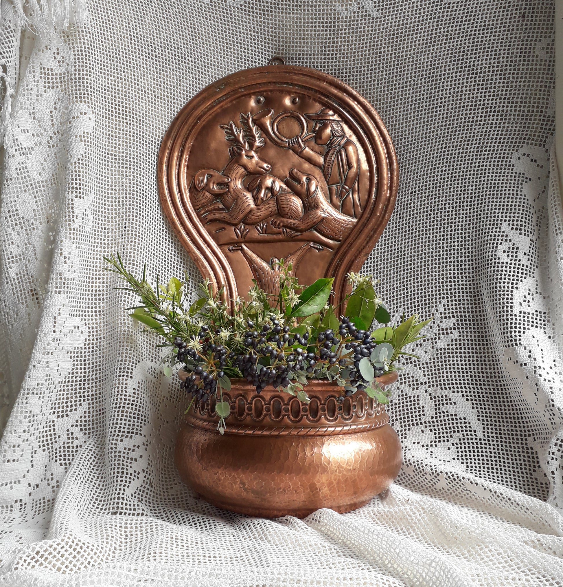 A very handsome copper vintage/antique wall-mounted planter with a hunting scene that I purchased in south west France.
This wonderful rustic piece may at some time have had another purpose, although being a planter seems to suit it just perfectly. There is a hanging hook to the rear, although it can also be displayed sitting on a flat surface as it's depicted in my photos - it's very interesting that we can also see the crude yet charming way this heavy copper planter was constructed by the artisan.